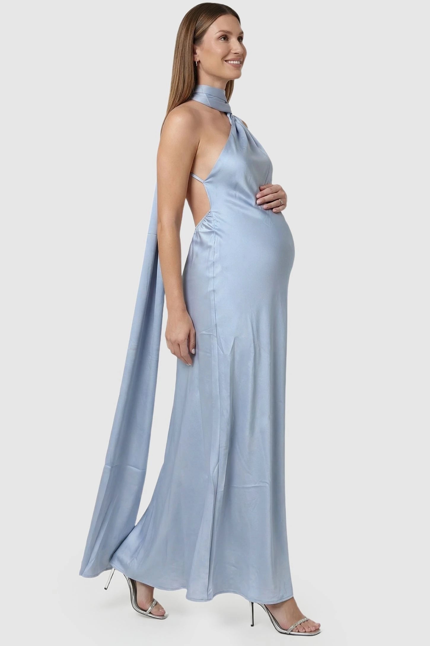 High-Shine Halter Sleeveless Maternity Maxi Dress High-Shine Halter Sleeveless Maternity Maxi Dress in Blue featuring an elegant side-profile drape on a pregnant model, side view.