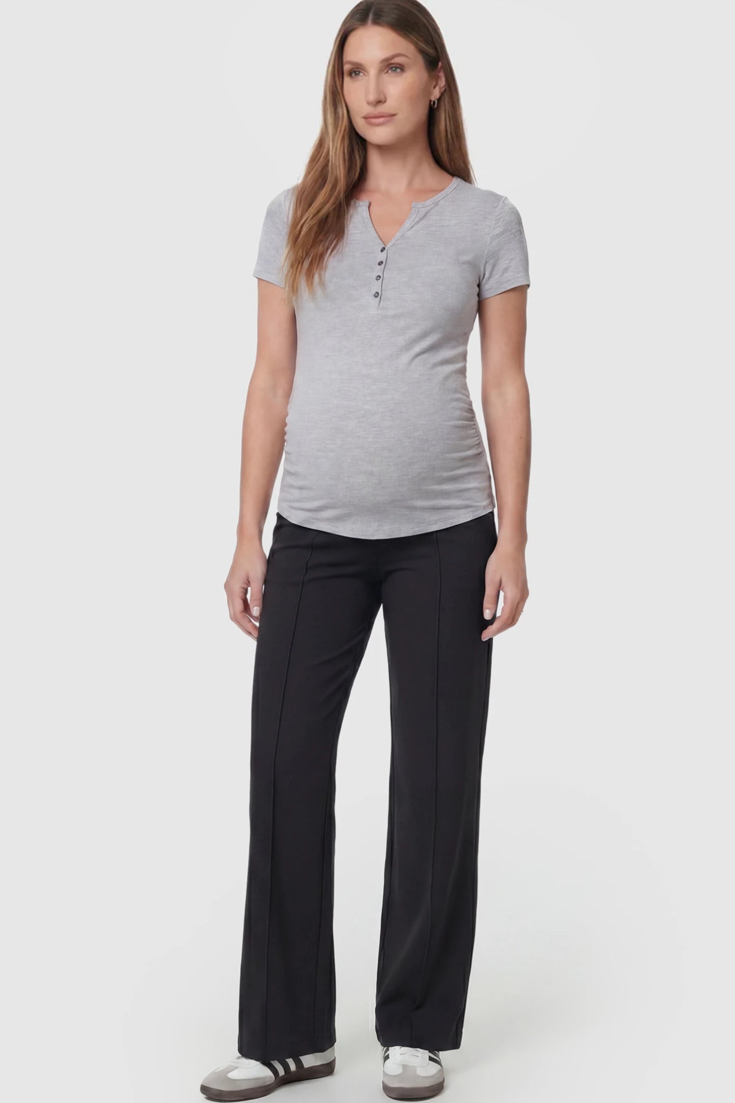 High-Stretch Wide Leg Pocketed Maternity Pants in Black featuring a seamless over-the-bump panel and side pocket on a pregnant model, full body view.