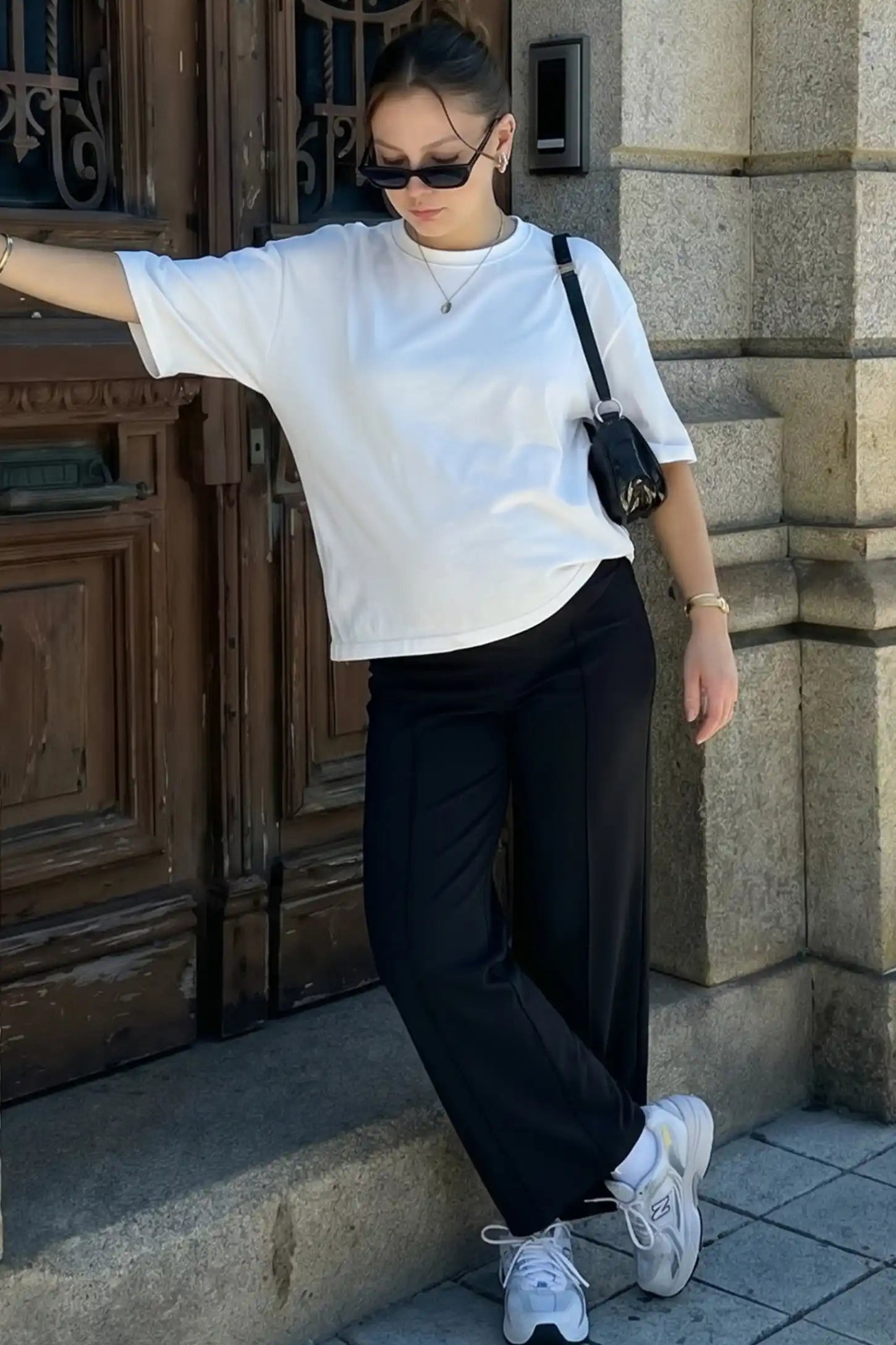 High Stretch Wide Leg Pocketed Maternity Pants High-Stretch Wide Leg Pocketed Maternity Pants in Black featuring a seamless over-the-bump panel and side pocket on a pregnant woman in outdoor setting, full body view.