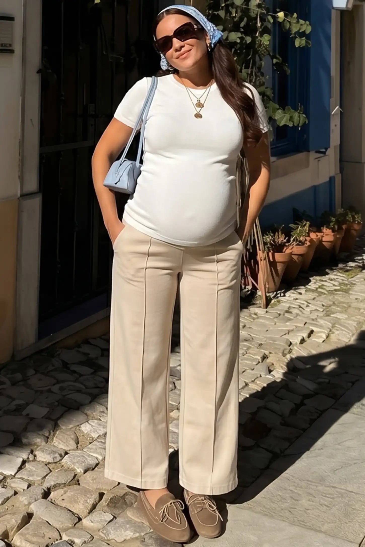 High Stretch Wide Leg Pocketed Maternity Pants High-Stretch Wide Leg Pocketed Maternity Pants in Off White featuring a seamless over-the-bump panel and side pocket on a pregnant woman in indoor setting, full body view.
