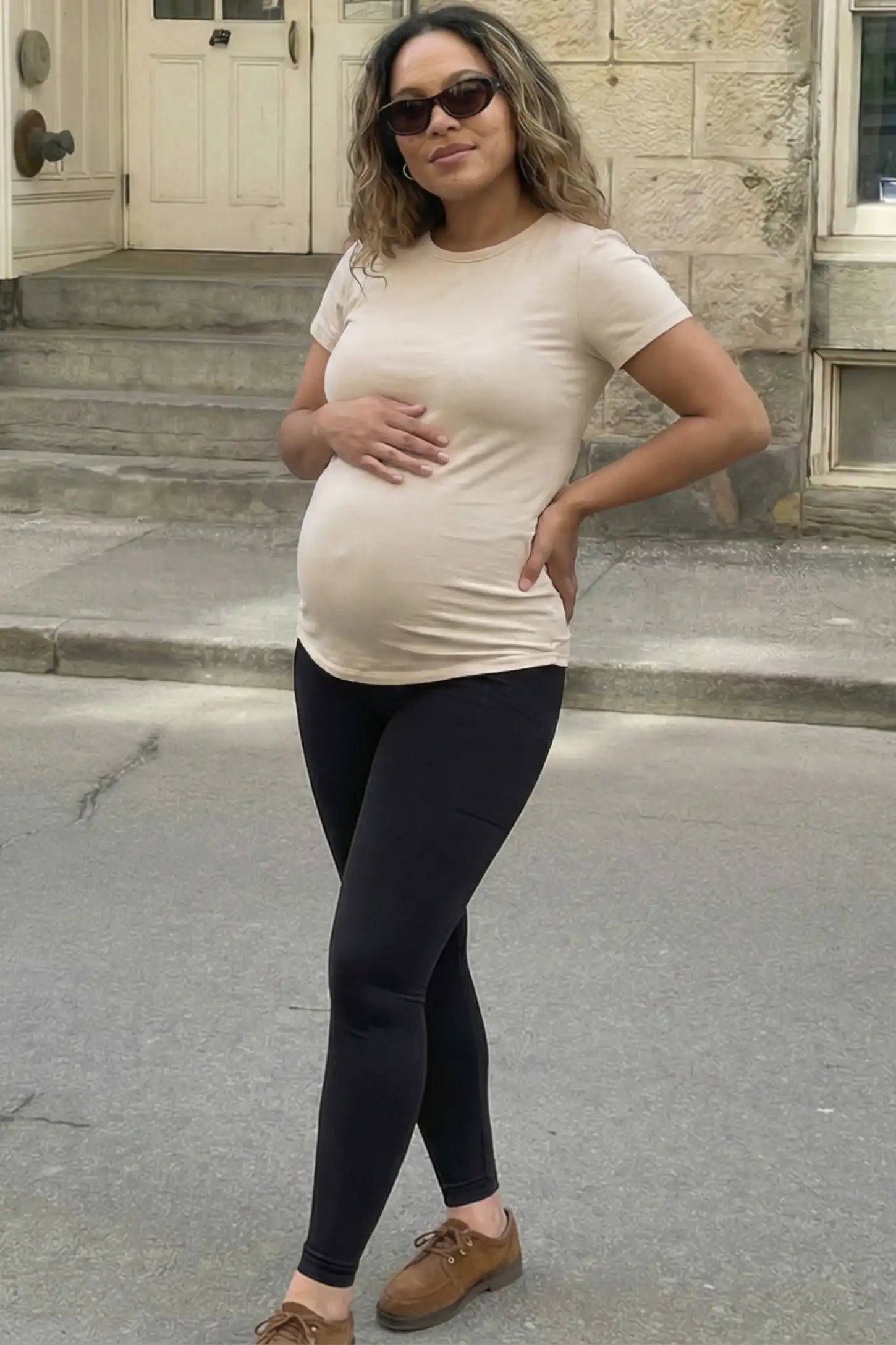 High Waist Ankle Length Pocketed Maternity Leggings High-Waist Ankle-Length Pocketed Maternity Leggings in Black featuring a seamless waistband on a pregnant woman, front view.