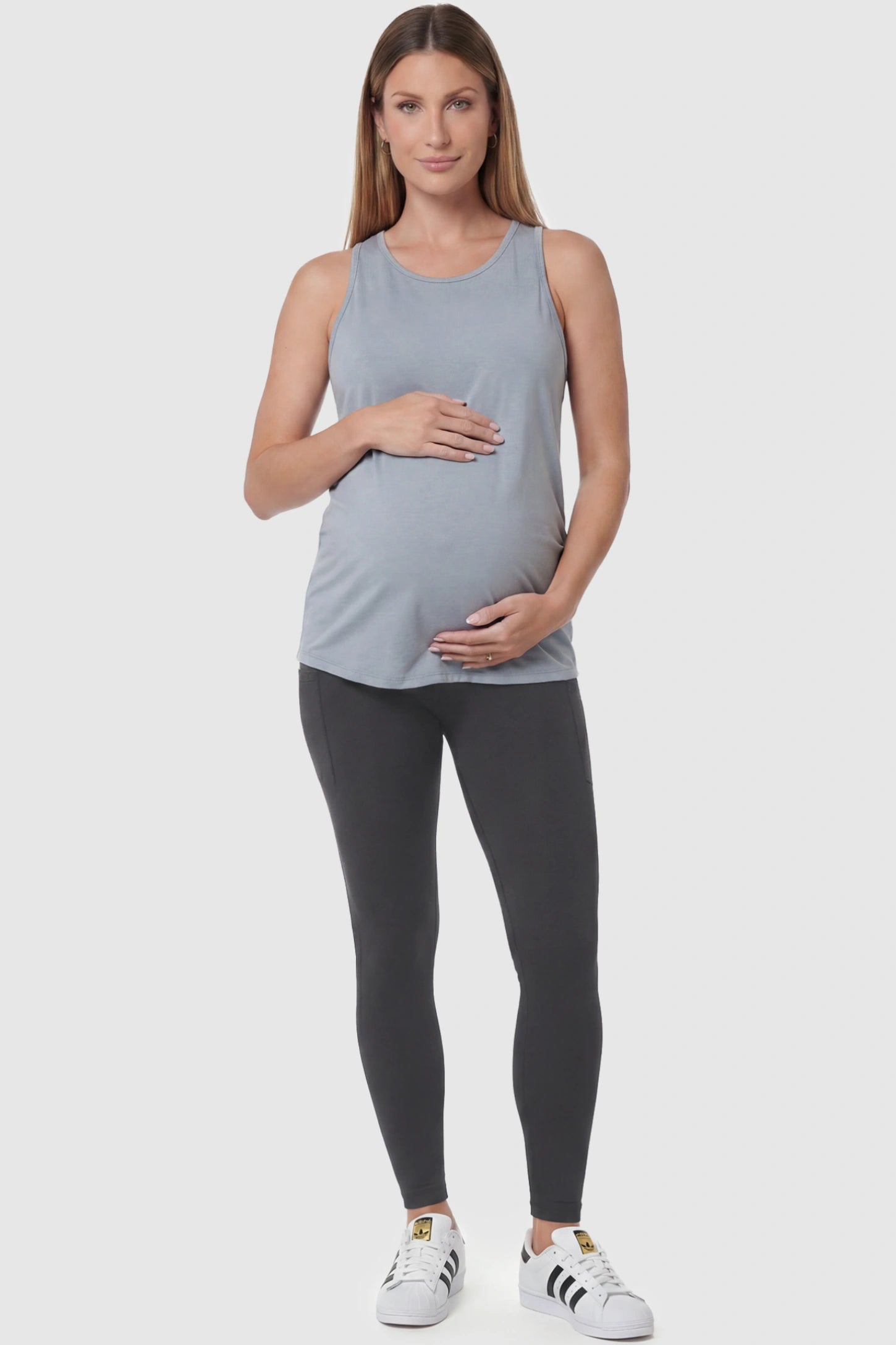 High Waist Ankle Length Pocketed Maternity Leggings High-Waist Ankle-Length Pocketed Maternity Leggings in Gray featuring a seamless waistband on a pregnant model, full body view.