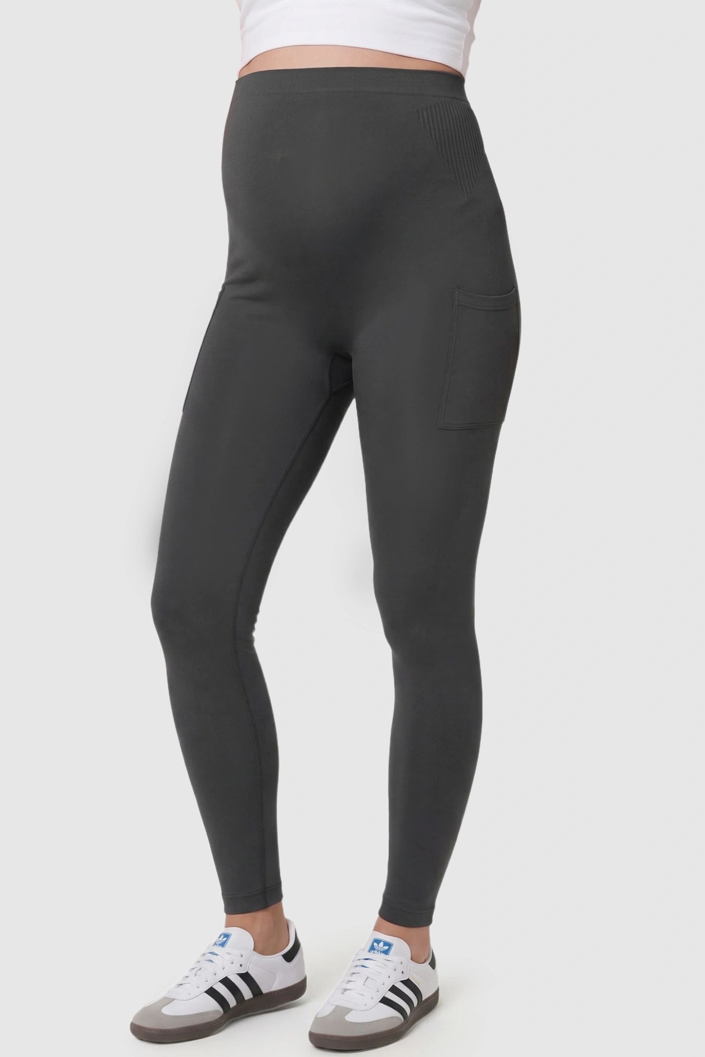 High Waist Ankle Length Pocketed Maternity Leggings High-Waist Ankle-Length Pocketed Maternity Leggings in Gray featuring a seamless waistband on a pregnant model, side view.