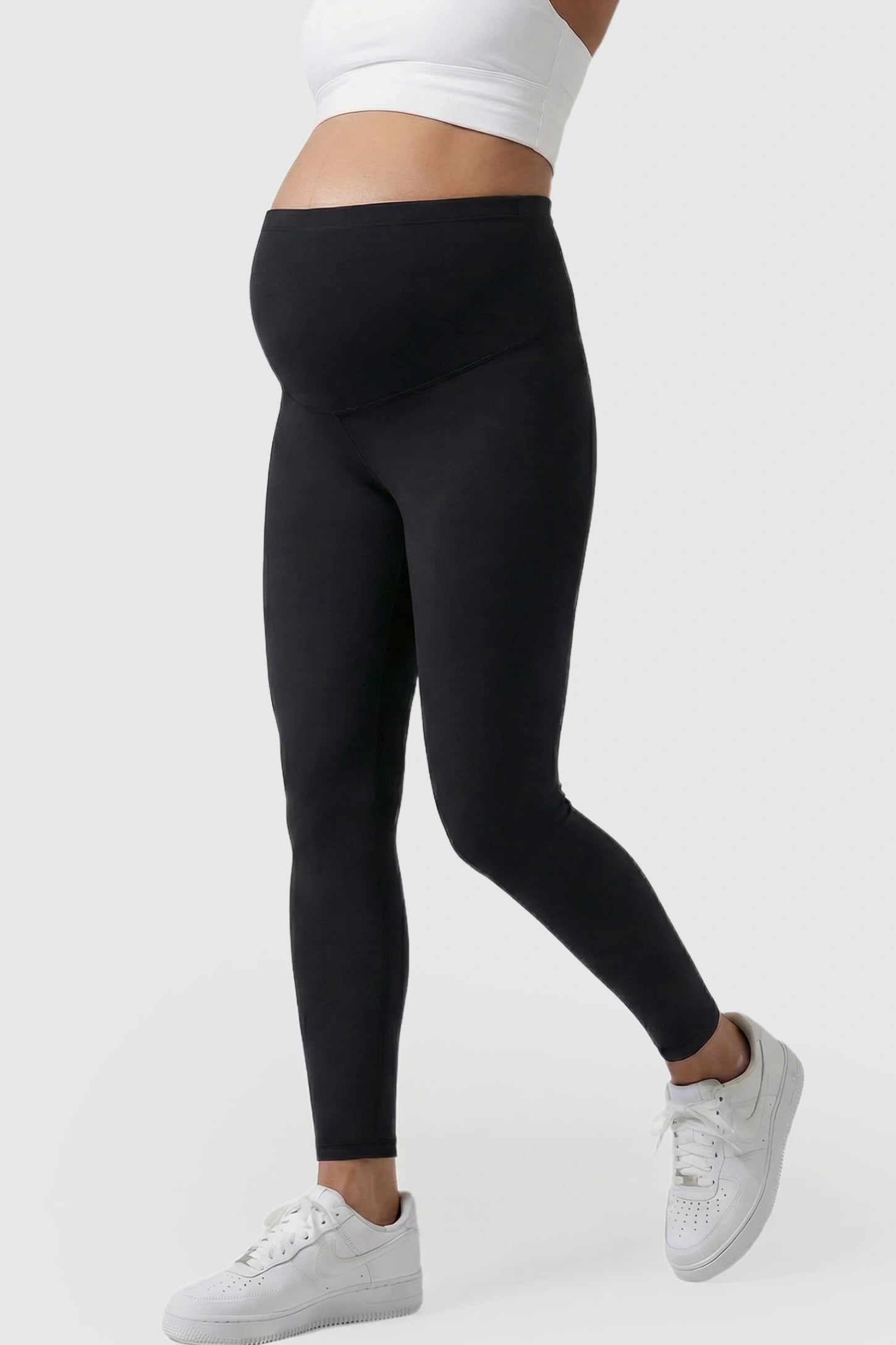 High Waist Belly Support Full Length Maternity Leggings High Waist Belly Support Full Length Maternity Leggings in black featuring molding waistband on a pregnant model showing side.