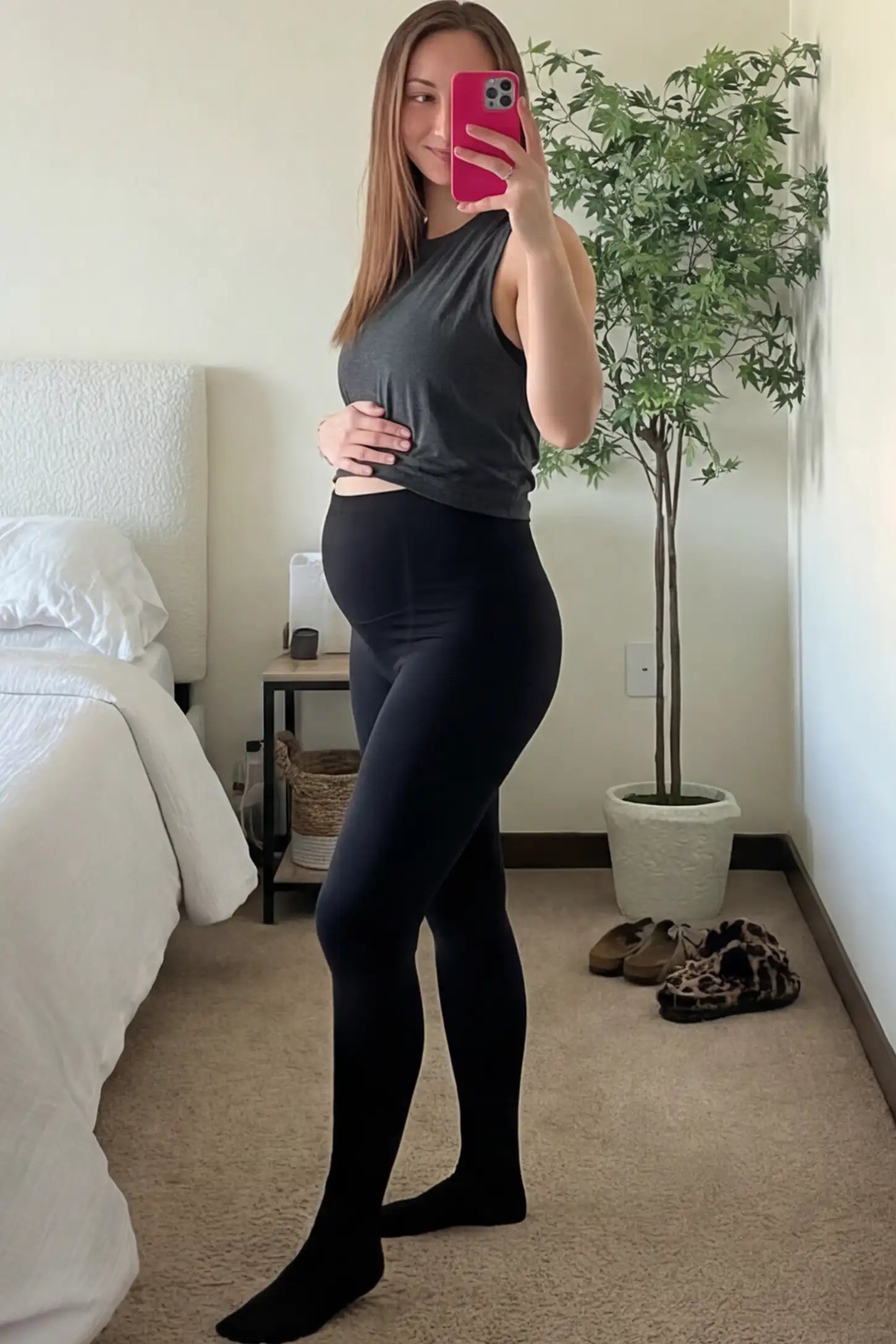 High Waist Fleece-Lined Stirrup Maternity Leggings High Waist Fleece-Lined Stirrup Maternity Leggings in Black featuring a supportive over-the-belly panel on a pregnant woman.