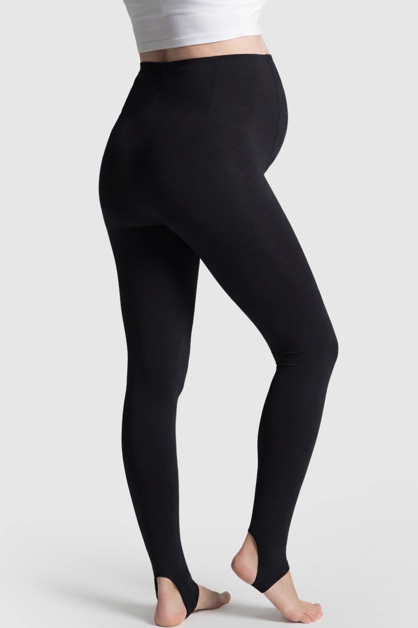 High Waist Fleece-Lined Stirrup Maternity Leggings High Waist Fleece-Lined Stirrup Maternity Leggings in Black featuring a Stirrup design on a pregnant model showing back.