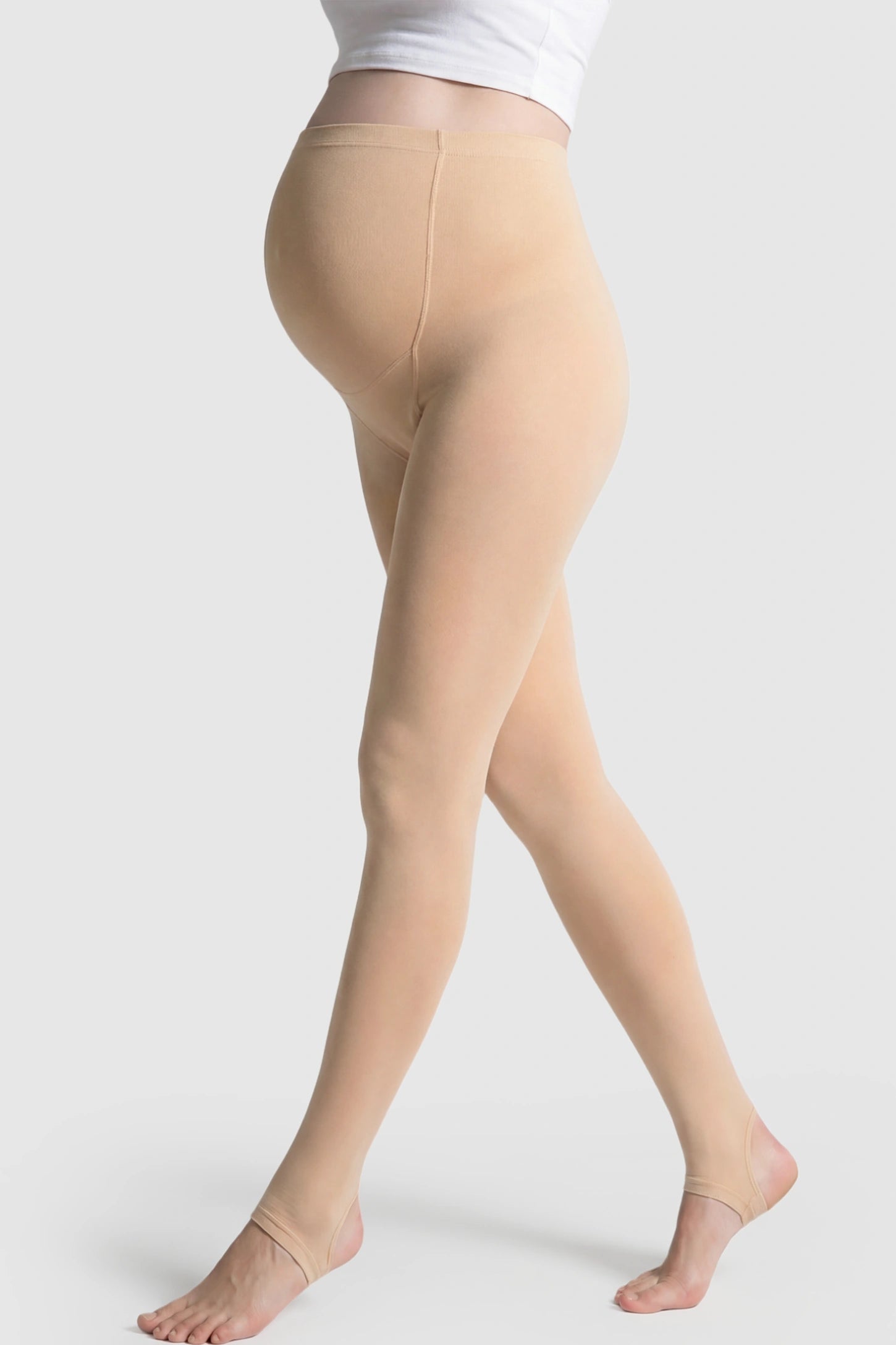 High Waist Fleece-Lined Stirrup Maternity Leggings High Waist Fleece-Lined Stirrup Maternity Leggings in Skin Tone featuring a supportive over-the-belly panel on a pregnant model showing side.