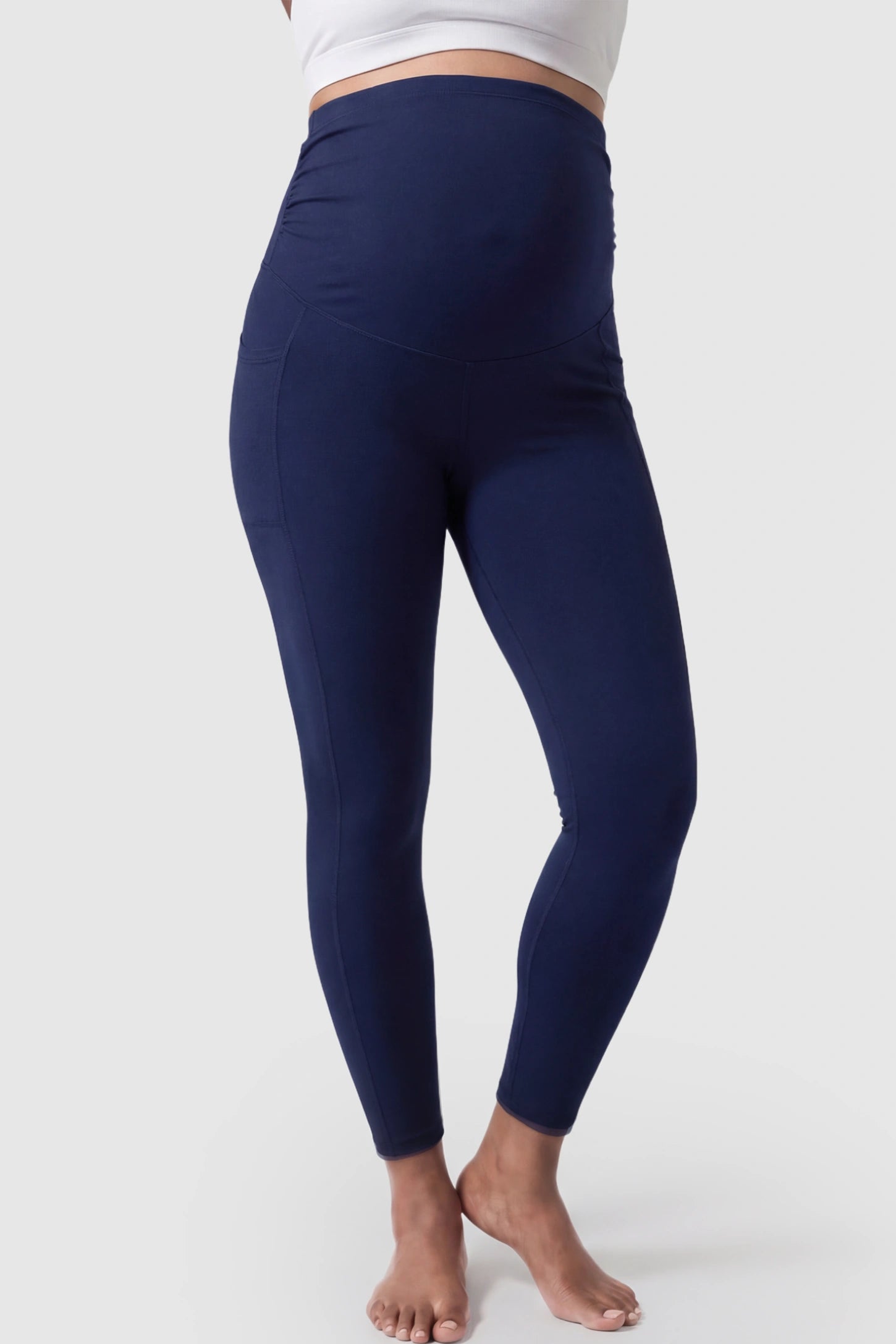 High Waist Full Panel Pocketed Maternity Leggings High Waist Full Panel Maternity Leggings in Navy Blue featuring side pockets on a pregnant model showing front.