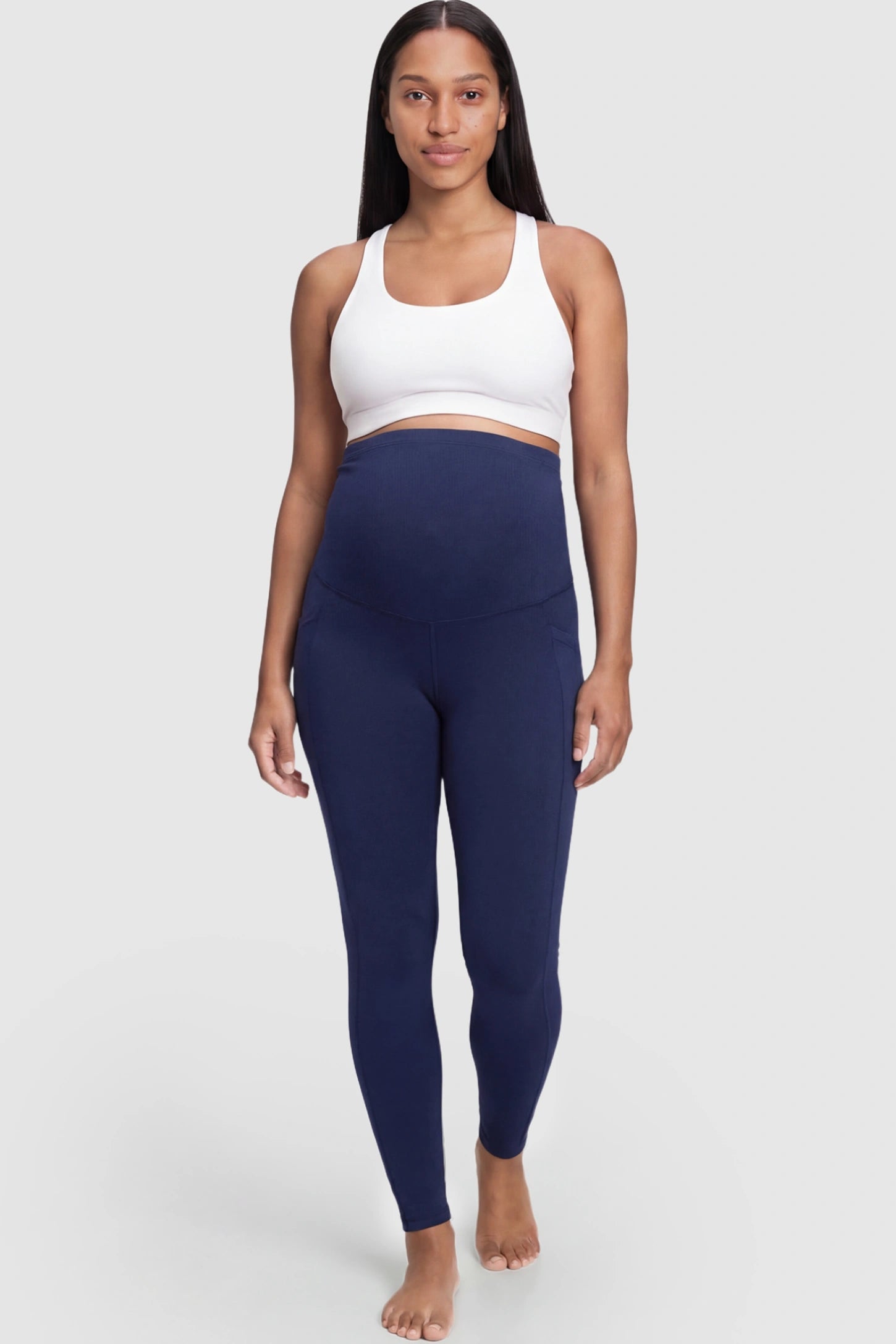 High Waist Full Panel Pocketed Maternity Leggings High Waist Full Panel Maternity Leggings in Navy Blue featuring side pockets on a pregnant model.
