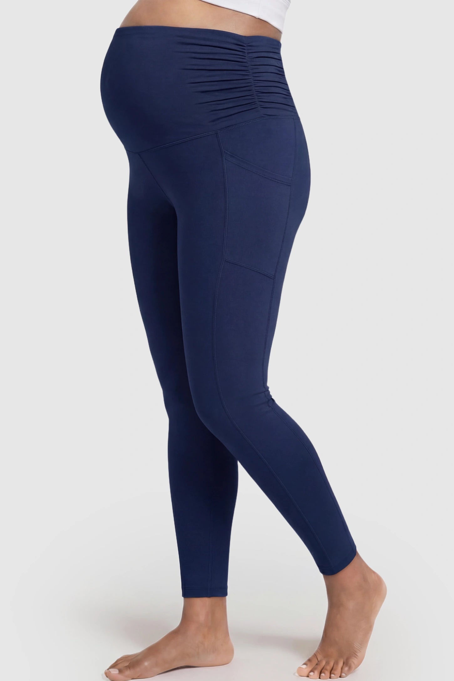 High Waist Full Panel Pocketed Maternity Leggings High Waist Full Panel Maternity Leggings in Navy Blue featuring side pockets on a pregnant model showing side.