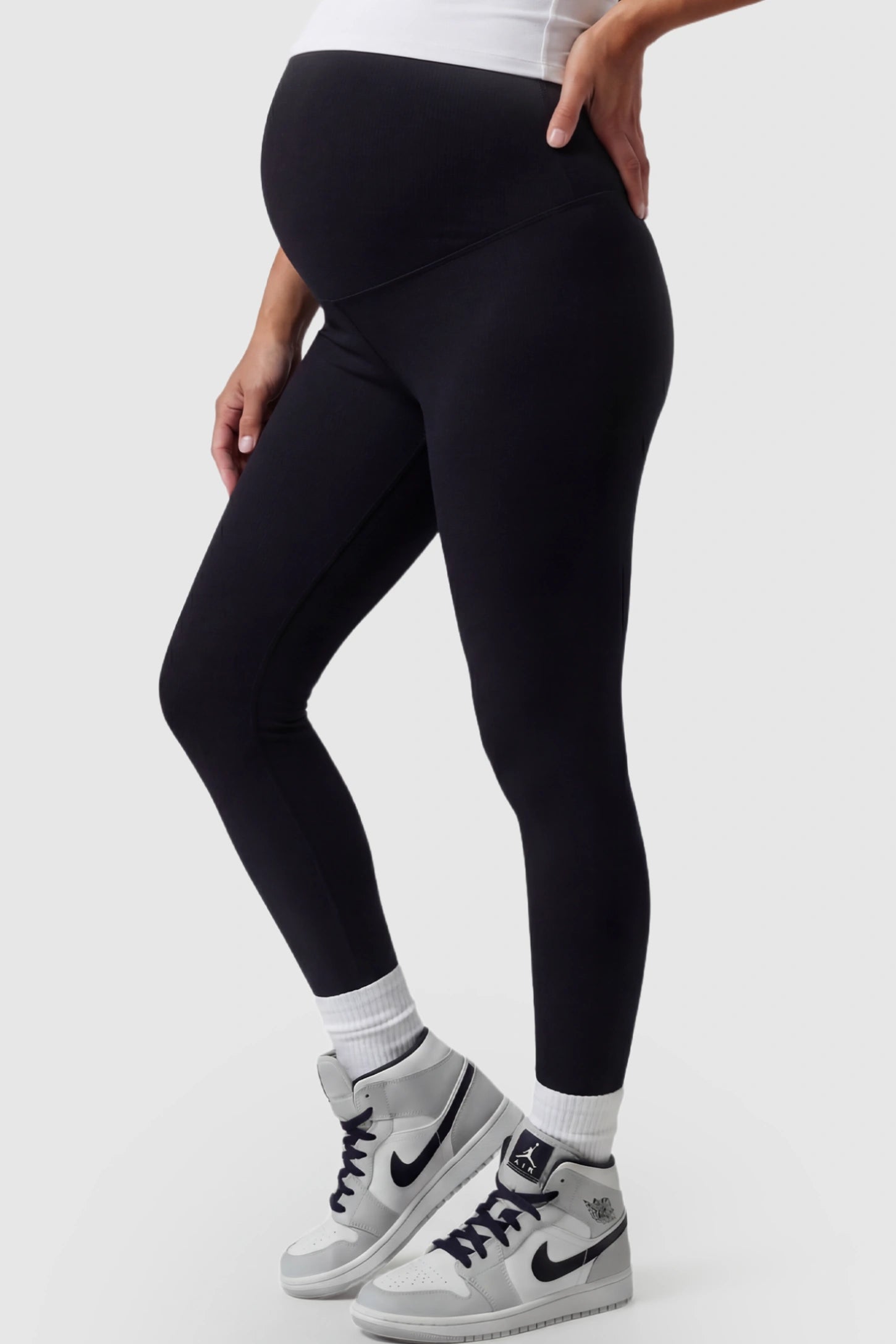 High Waist Slim Fit Maternity Leggings High Waist Slim Fit Maternity Leggings in Black featuring a seamless full-panel on a pregnant model side view.