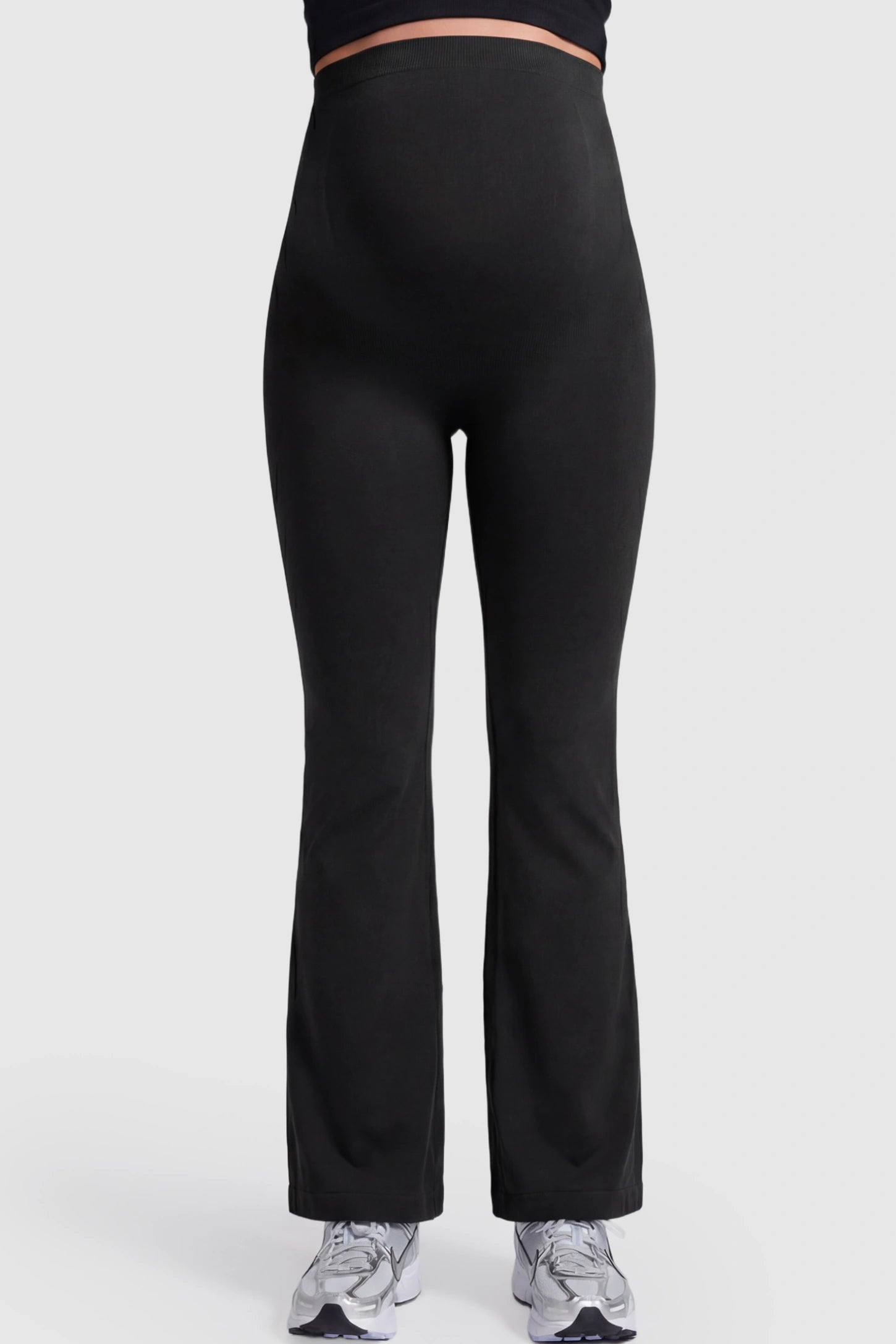 High Waisted Flare Leg Maternity Pants High Waisted Flare Leg Maternity Pants in black featuring a flexible over-the-belly support band on a pregnant model.