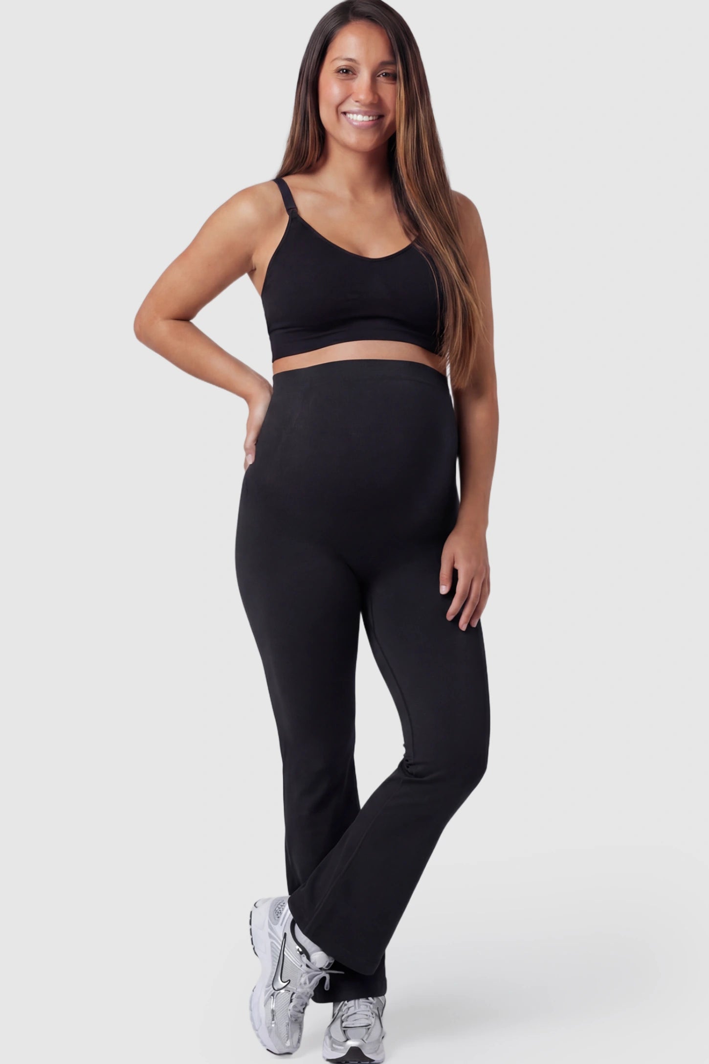 High Waisted Flare Leg Maternity Pants High Waisted Flare Leg Maternity Pants in black featuring a flexible over-the-belly support band on a pregnant model.