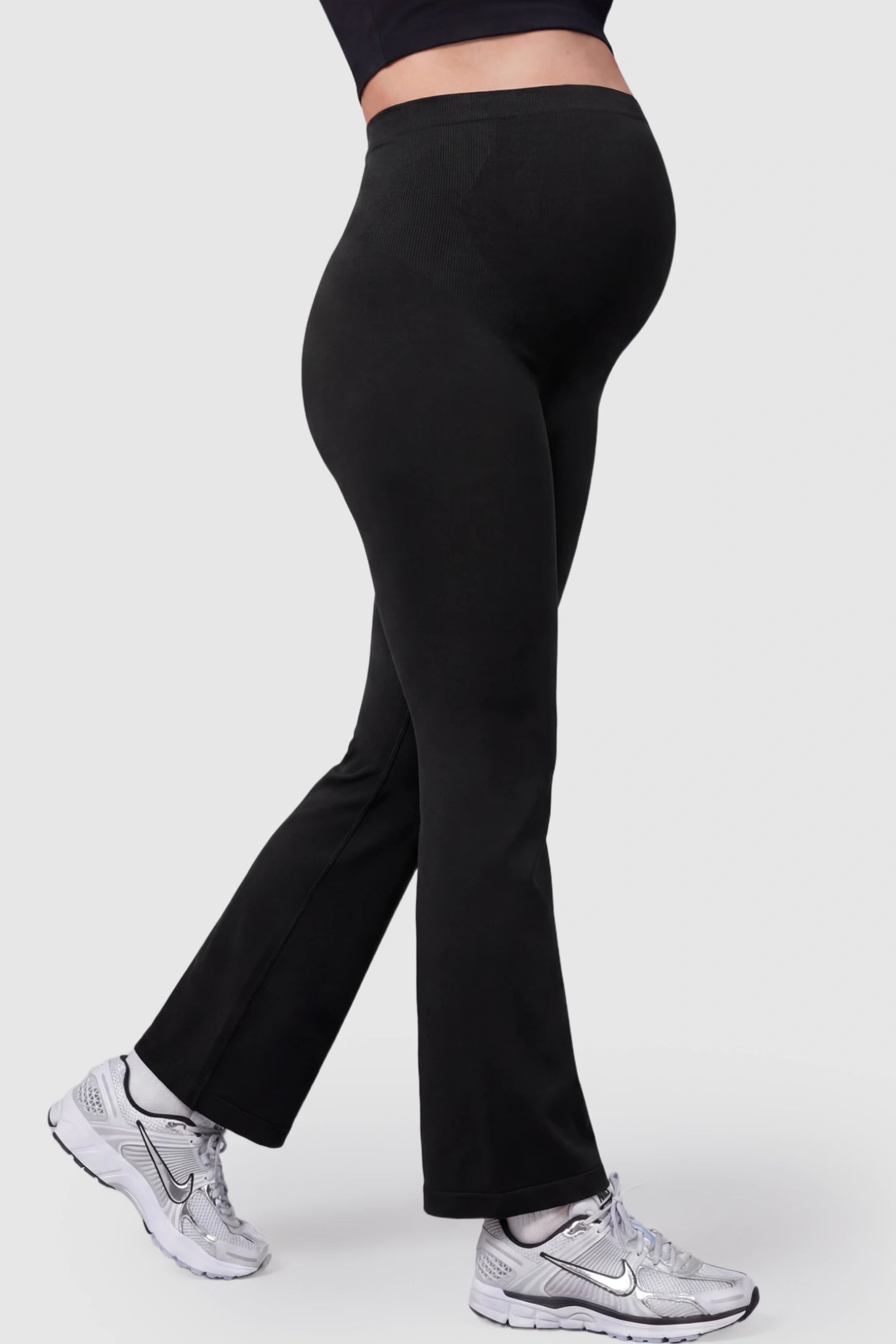 High Waisted Flare Leg Maternity Pants High Waisted Flare Leg Maternity Pants in black featuring a flexible over-the-belly support band on a pregnant model.