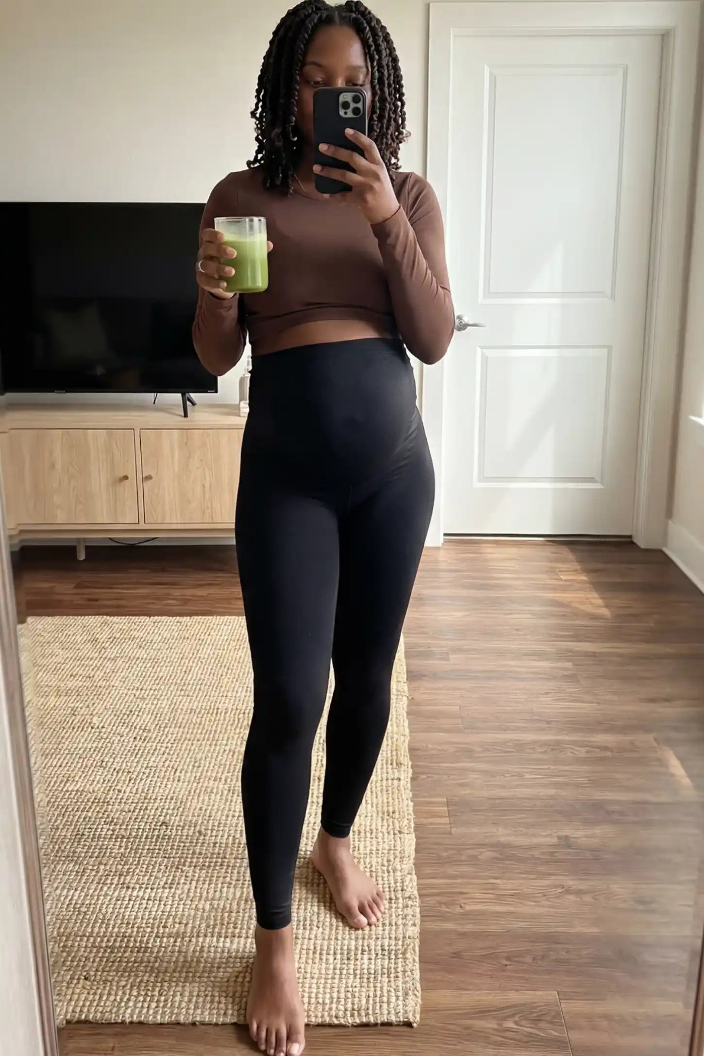 High Waisted Full Length Maternity Leggings High Waisted Full Length Maternity Leggings in Black featuring a seamless over-the-bump band on a pregnant woman showing front.