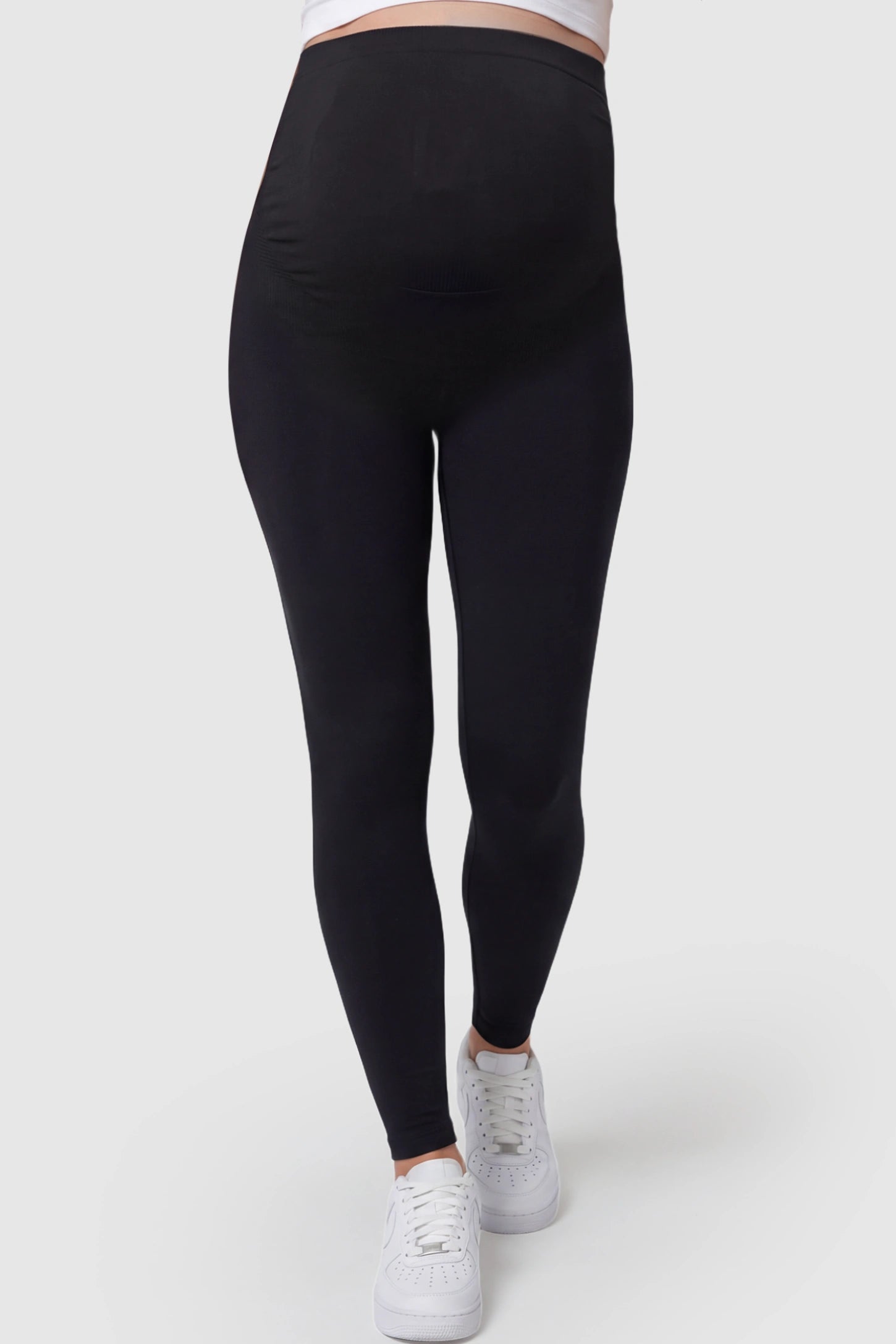 High Waisted Full Length Maternity Leggings High Waisted Full Length Maternity Leggings in Black featuring a seamless over-the-bump band on a pregnant model showing front.