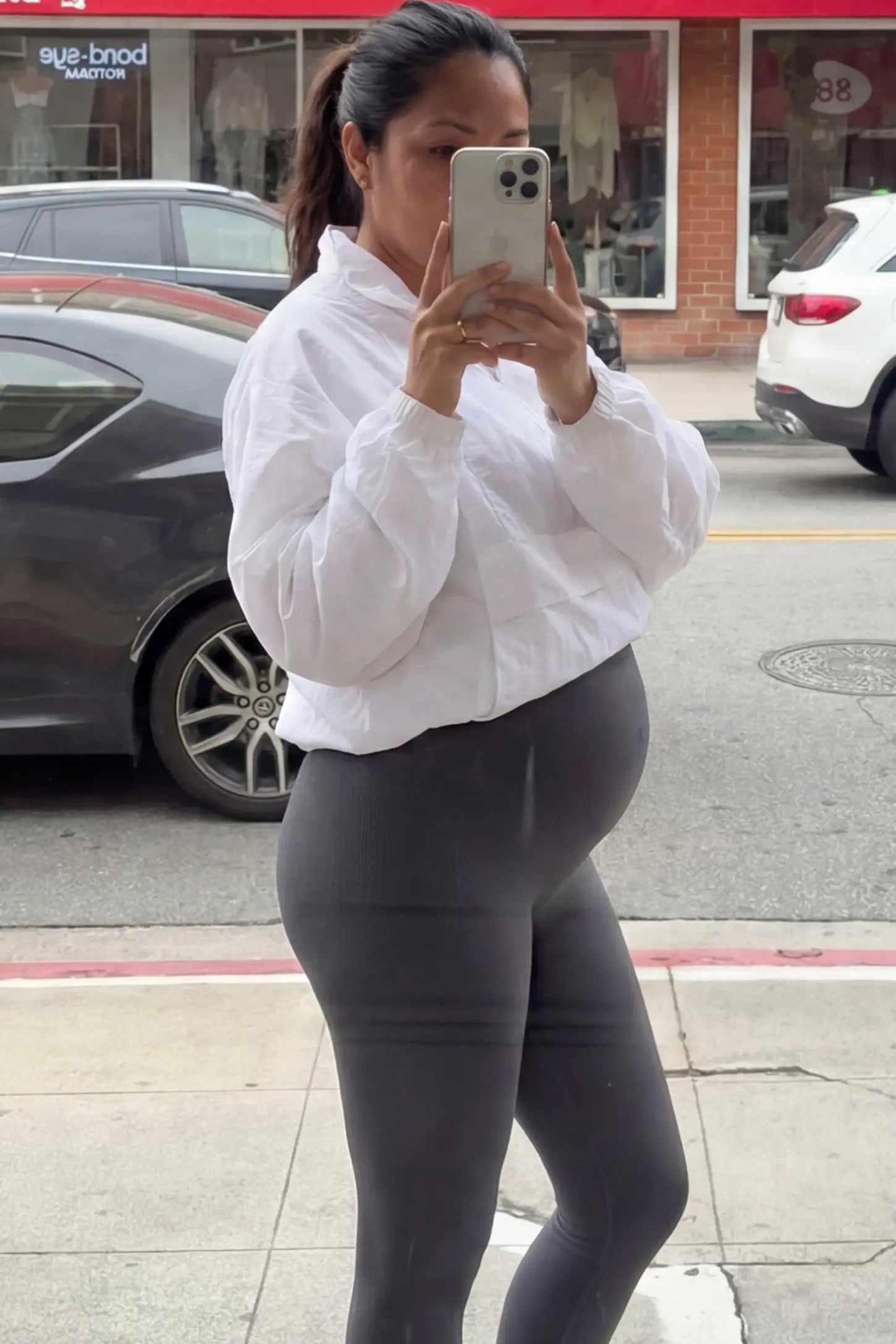 High Waisted Full Length Maternity Leggings High Waisted Full Length Maternity Leggings in Gray featuring a seamless over-the-bump band on a pregnant woman.