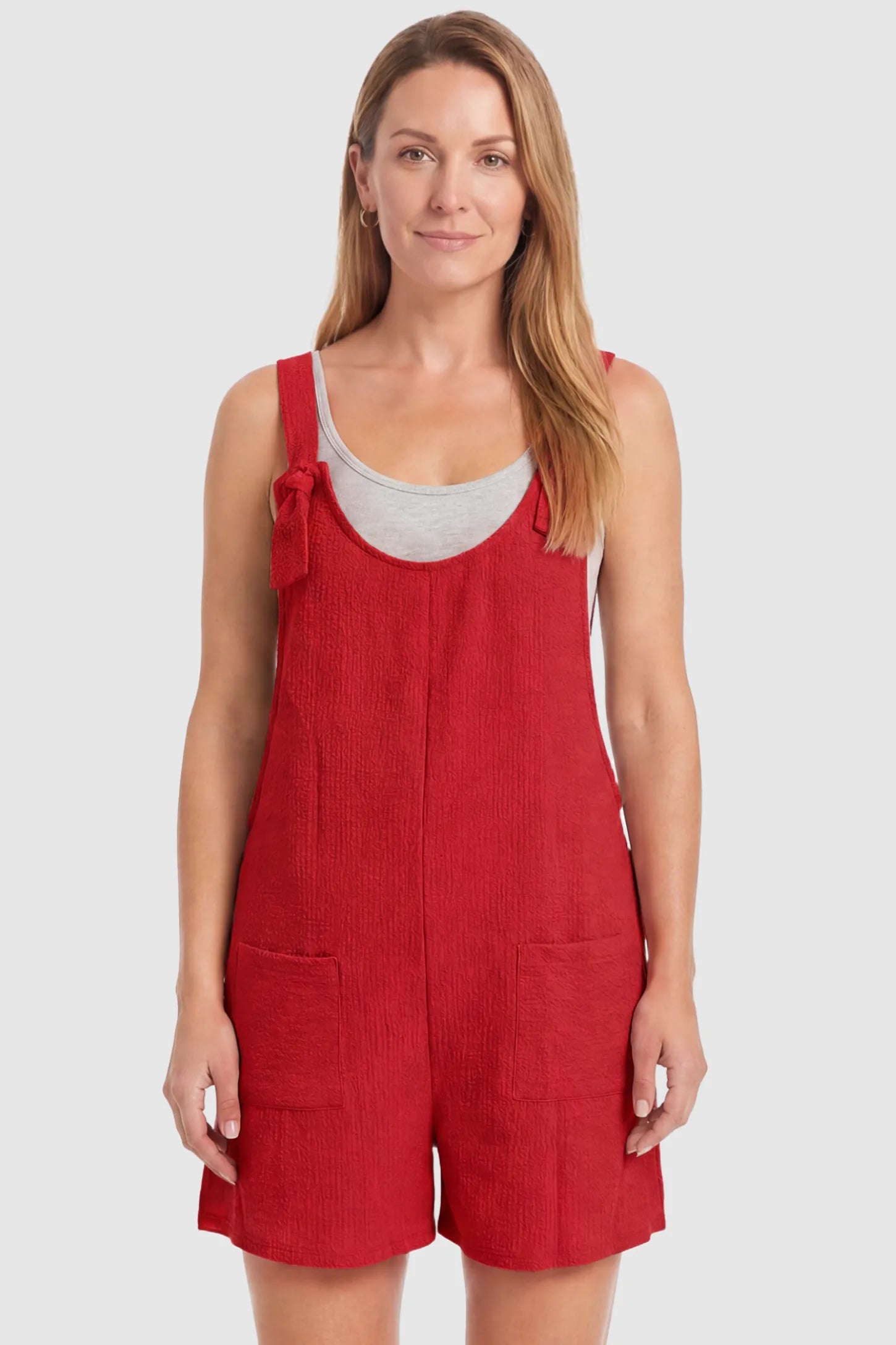 Knot Strap Front Pocket Maternity Romper Knot Strap Front Pocket Maternity Romper in Red featuring deep front pockets and a scoop neck on a postpartum model, front view.
