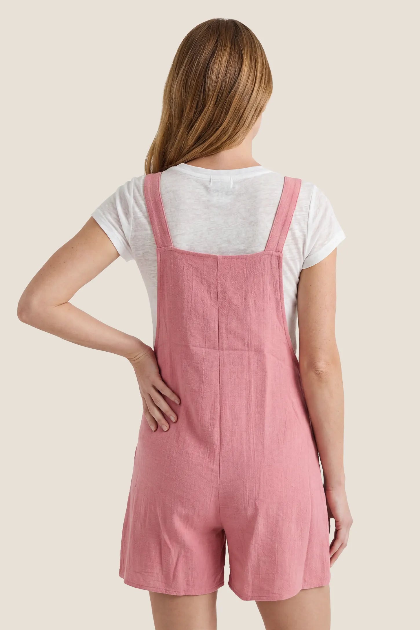 Knot Strap Front Pocket Maternity Romper Back view of the pink Knot Strap Front Pocket Maternity Romper with a relaxed fit and sleeveless silhouette.