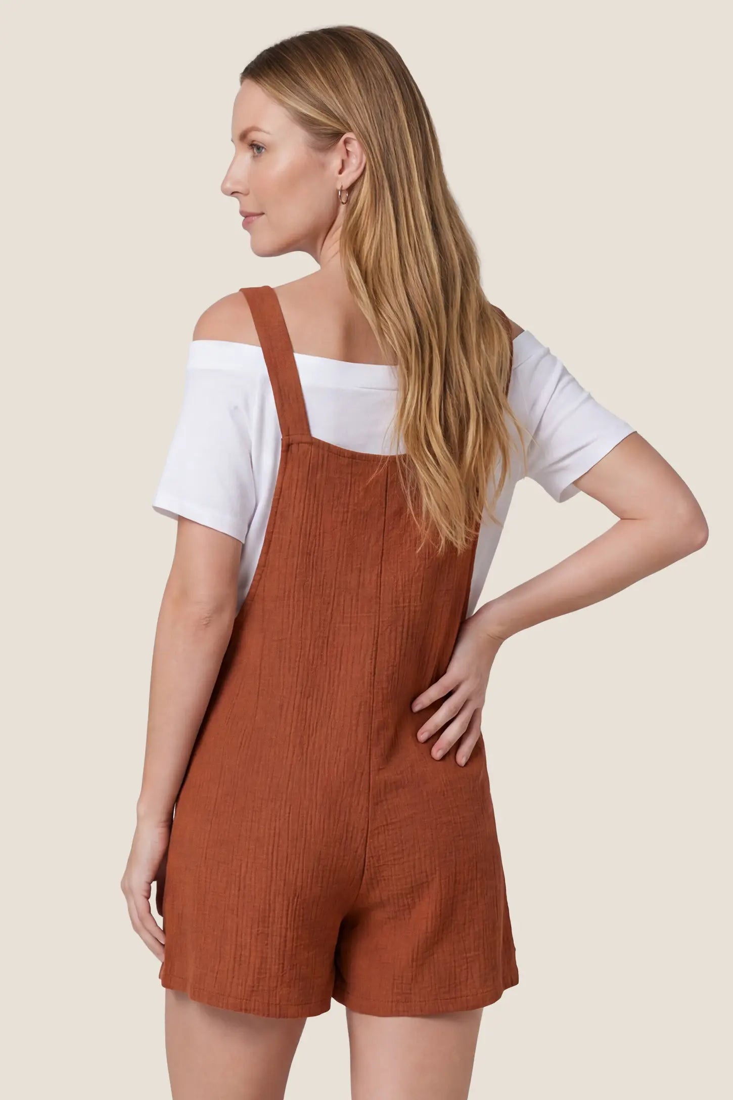 Knot Strap Front Pocket Maternity Romper Back view of the rust Knot Strap Front Pocket Maternity Romper with a relaxed maternity fit and tied shoulder straps.