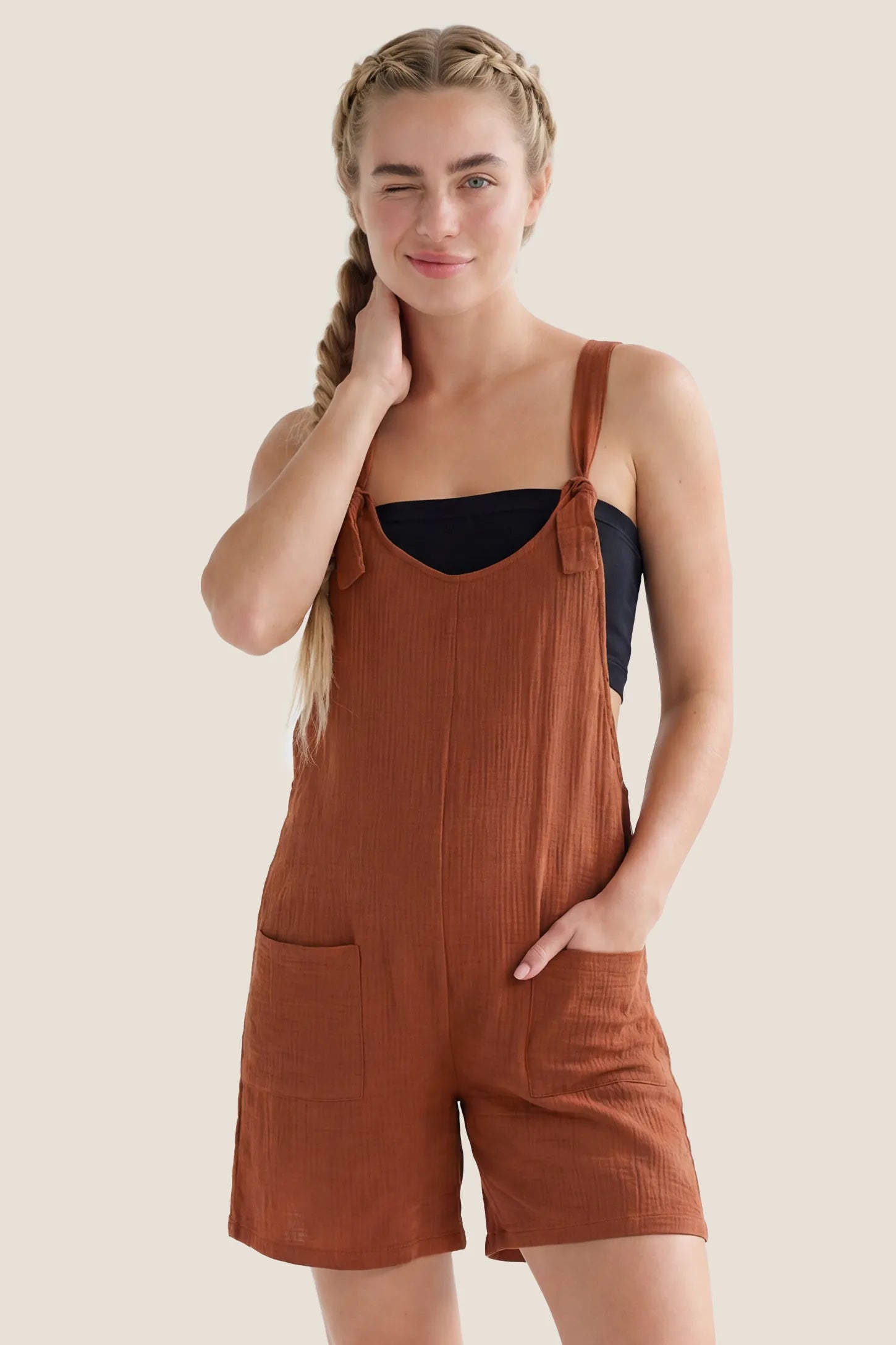 Knot Strap Front Pocket Maternity Romper Front view of the rust Knot Strap Front Pocket Maternity Romper featuring knot shoulder straps and front pockets.