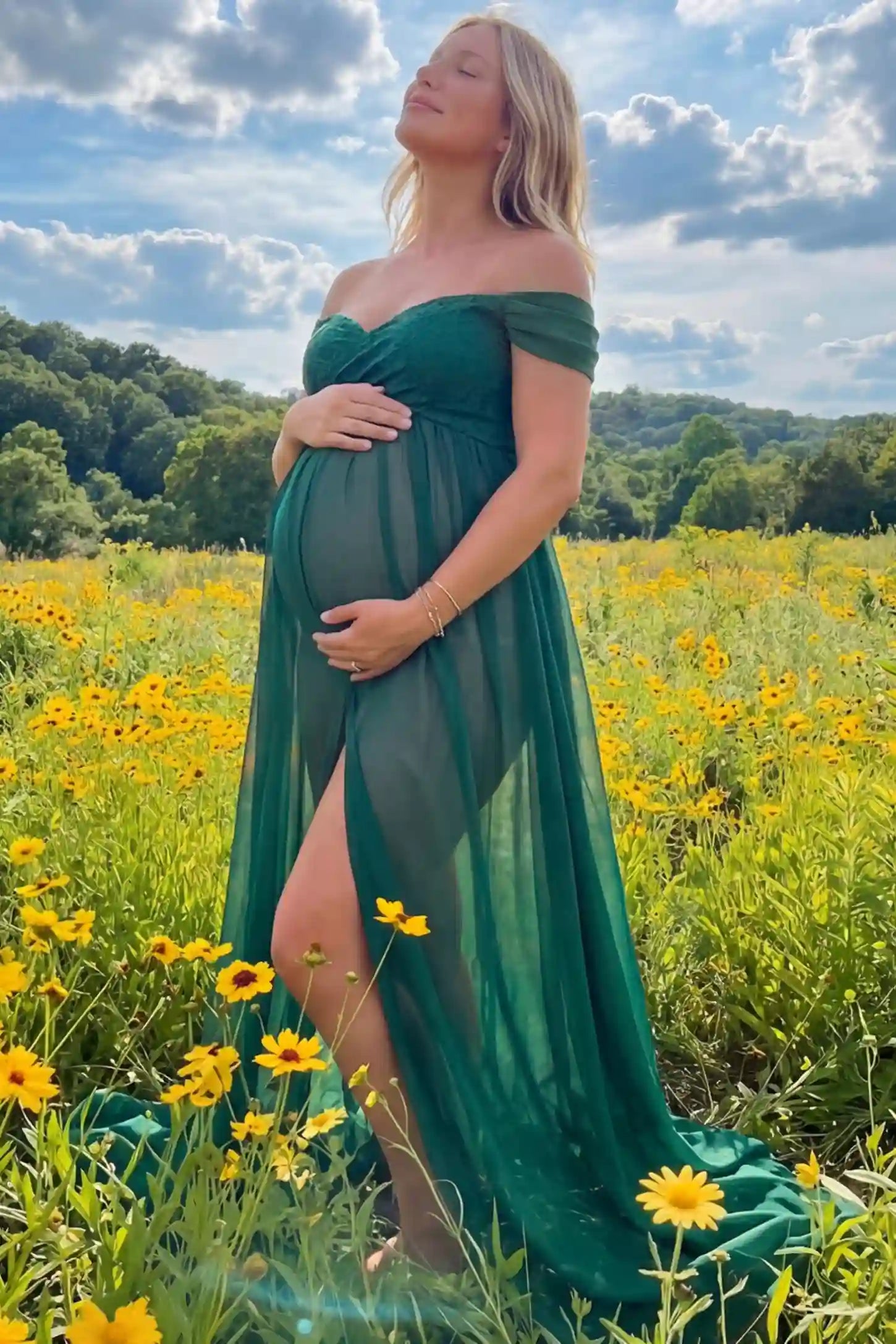 Lace Off Shoulder Slit Front Maternity Gown Lace Off Shoulder Slit Front Maternity Gown in Dark Green featuring off shoulder and high slit front on a pregnant woman during outdoor photoshoot.
