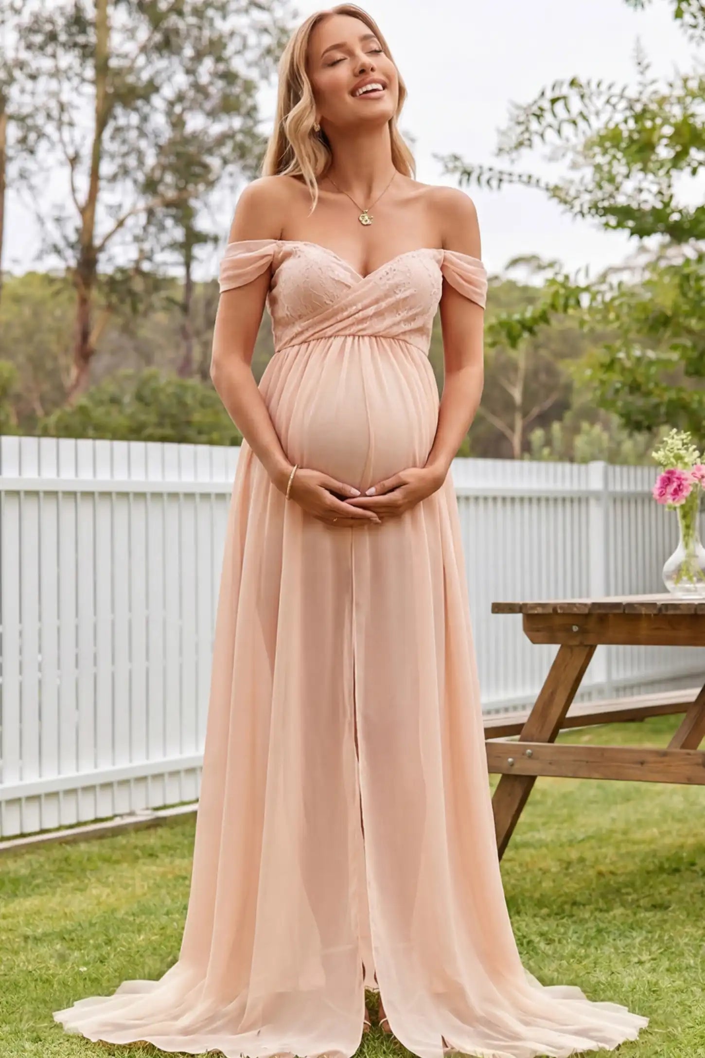 Lace Off Shoulder Slit Front Maternity Gown Lace Off Shoulder Slit Front Maternity Gown in Pink featuring off shoulder and high slit front on a pregnant woman during outdoor photoshoot.