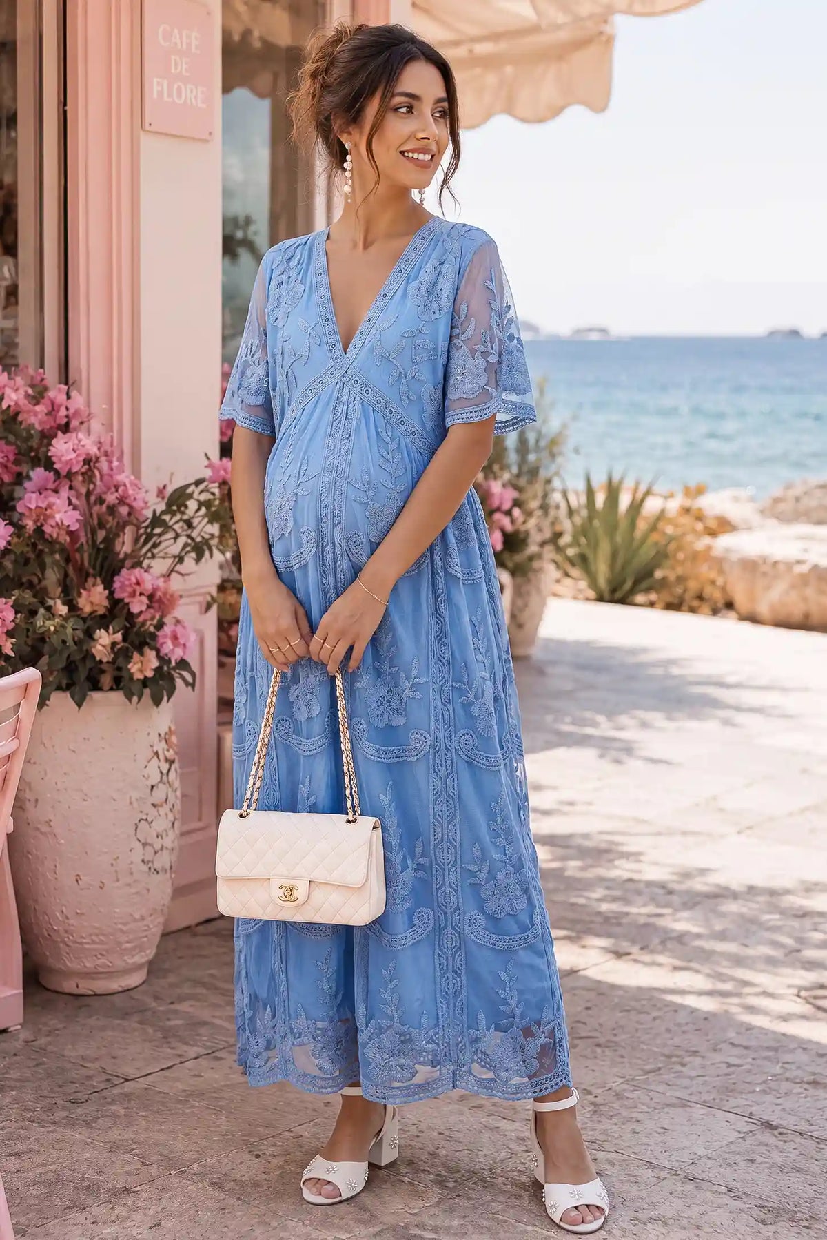 Lace Short Sheer Sleeve Maternity Maxi Dress Lace Short Sheer Sleeve Maternity Maxi Dress in Blue with delicate lace and sheer sleeves, lifestyle view on a pregnant model.
