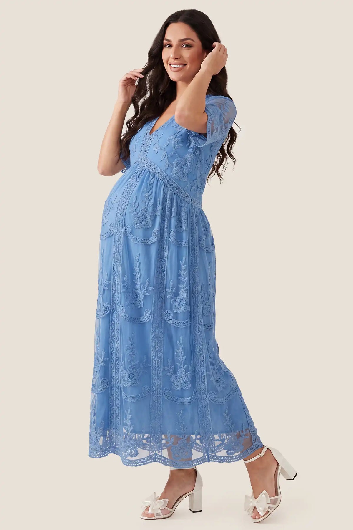 Lace Short Sheer Sleeve Maternity Maxi Dress Lace Short Sheer Sleeve Maternity Maxi Dress in Blue with an empire waist and flowing skirt, side view on a pregnant model.