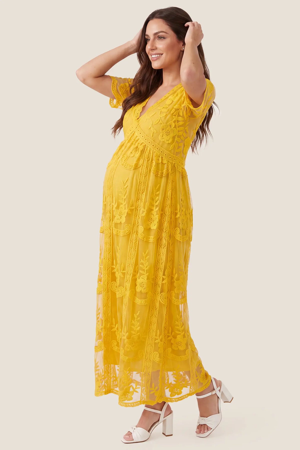 Lace Short Sheer Sleeve Maternity Maxi Dress Lace Short Sheer Sleeve Maternity Maxi Dress in Lemon Sorbet with an empire waist and flowing skirt, side view on a pregnant model.