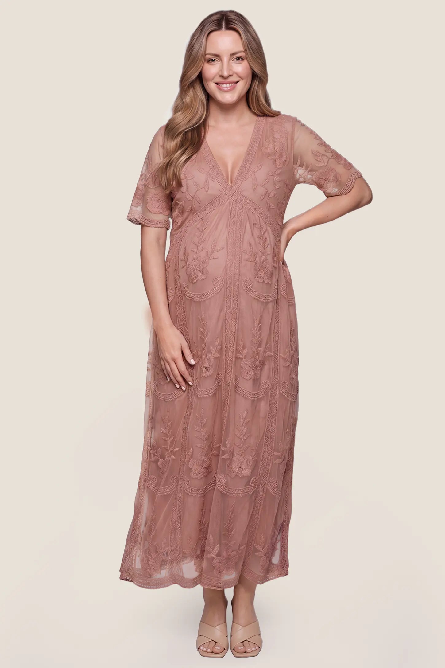 Lace Short Sheer Sleeve Maternity Maxi Dress Lace Short Sheer Sleeve Maternity Maxi Dress in Pink featuring short sheer sleeves and a floral lace overlay, front view on a pregnant model.