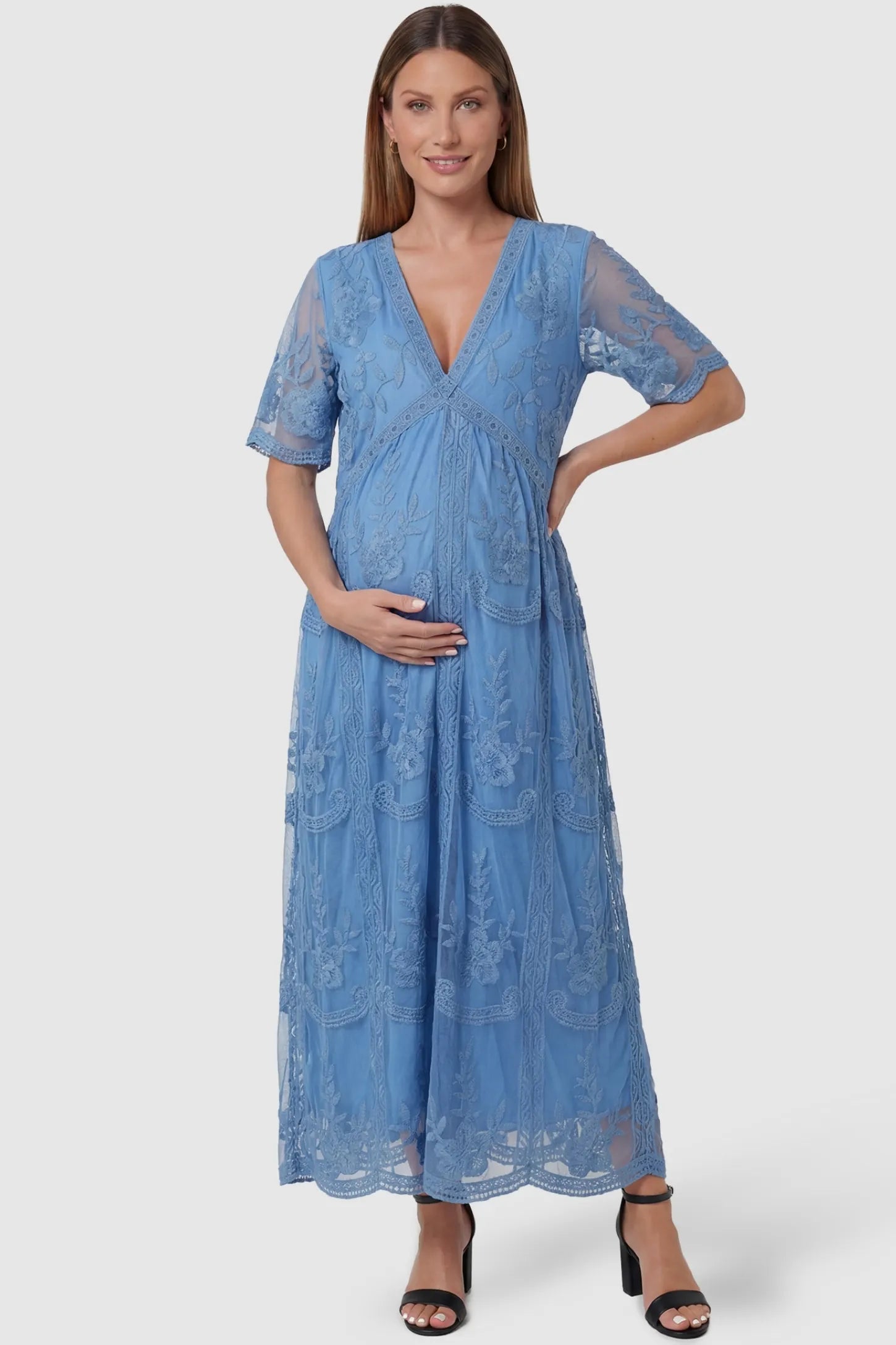 Lace Short Sheer Sleeve Maternity Maxi Dress Lace Short Sheer Sleeve Maternity Maxi Dress in blue featuring elegant floral embroidery on a pregnant model, front view.