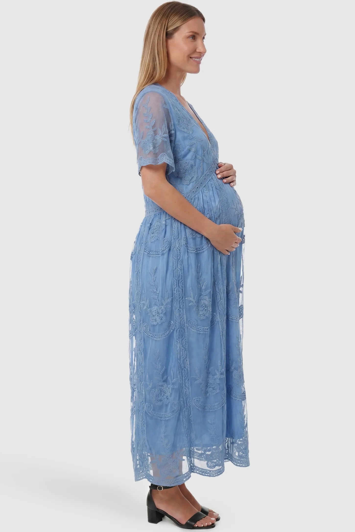Lace Short Sheer Sleeve Maternity Maxi Dress Lace Short Sheer Sleeve Maternity Maxi Dress in blue featuring a delicate lace overlay on a pregnant model, side view.