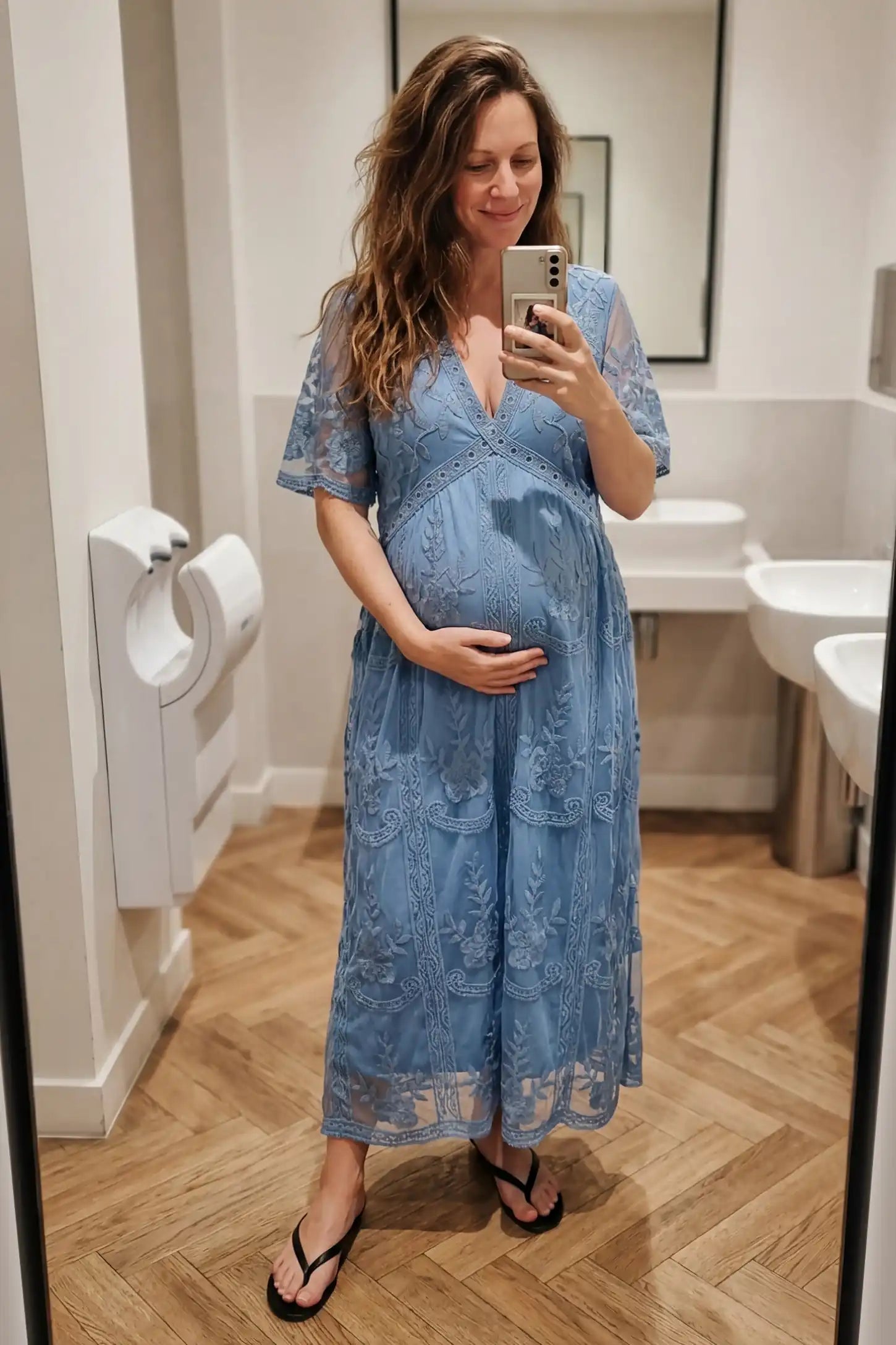 Lace Short Sheer Sleeve Maternity Maxi Dress Lace Short Sheer Sleeve Maternity Maxi Dress in blue featuring sheer floral details on a pregnant model, editorial lifestyle view.
