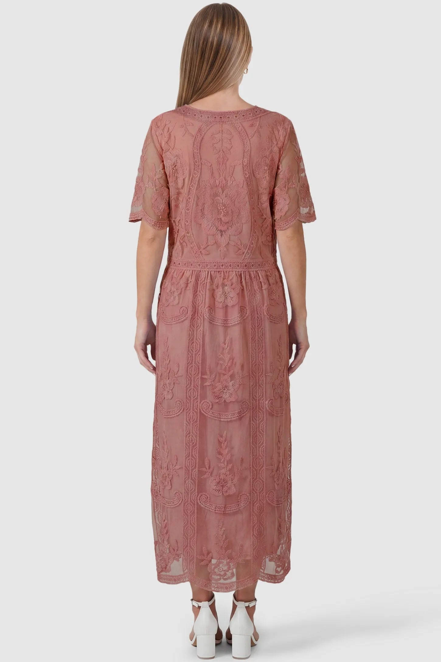Lace Short Sheer Sleeve Maternity Maxi Dress Lace Short Sheer Sleeve Maternity Maxi Dress in pink featuring scalloped hemline and sheer fabric on a pregnant model, back view.