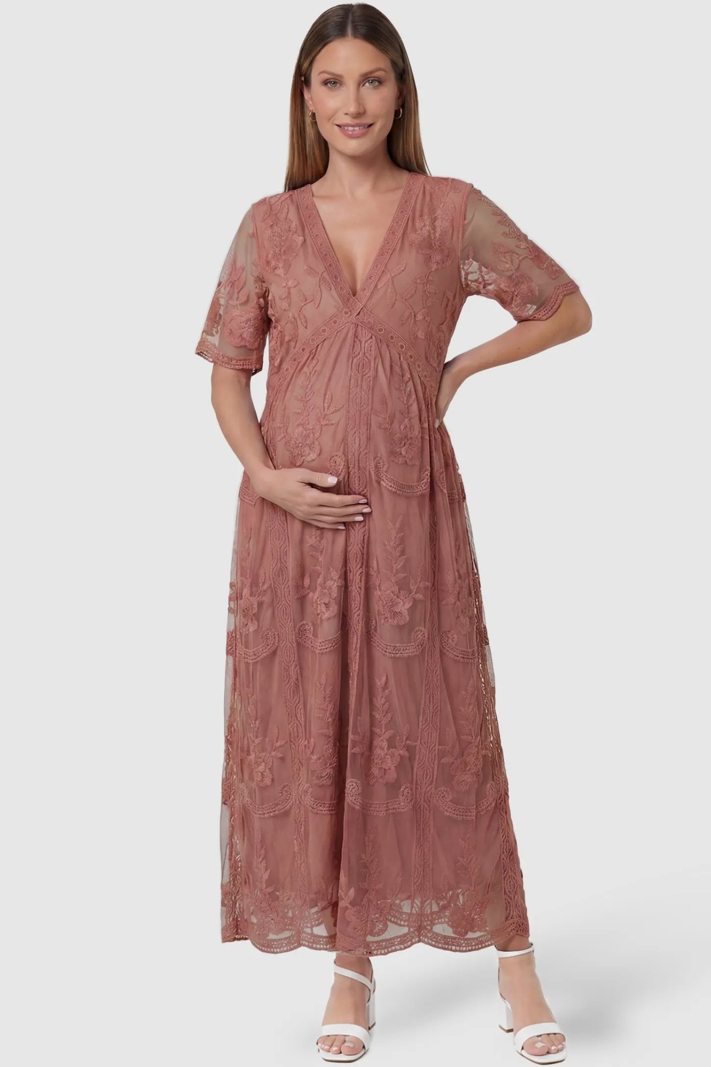 Lace Short Sheer Sleeve Maternity Maxi Dress Lace Short Sheer Sleeve Maternity Maxi Dress in pink featuring embroidered mesh overlay on a pregnant model, front view.
