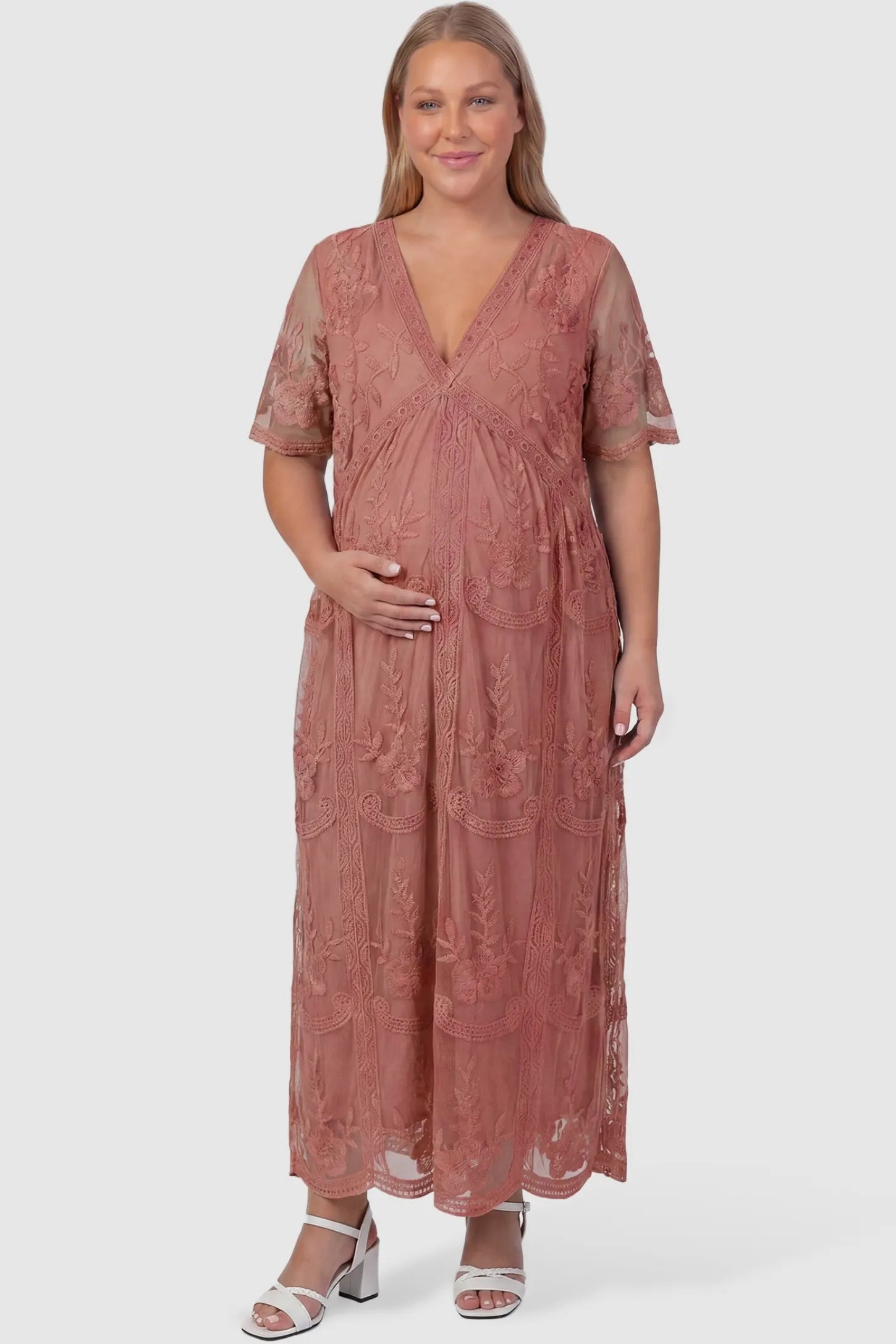 Lace Short Sheer Sleeve Maternity Maxi Dress Lace Short Sheer Sleeve Maternity Maxi Dress in pink featuring embroidered mesh overlay on a plus-size pregnant model, front view.