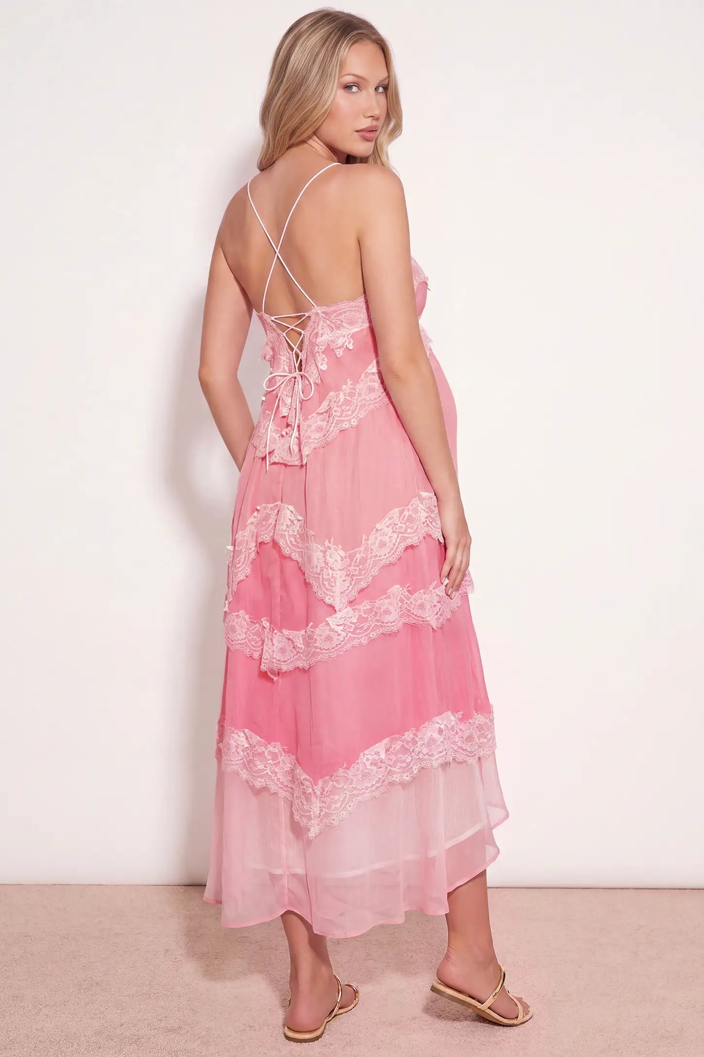 Lace Trim Lace-Up Tiered Maternity Maxi Dress Lace Trim Lace-Up Tiered Maternity Maxi Dress in Blush Pink showcasing the strappy back design on a pregnant model, studio back view.