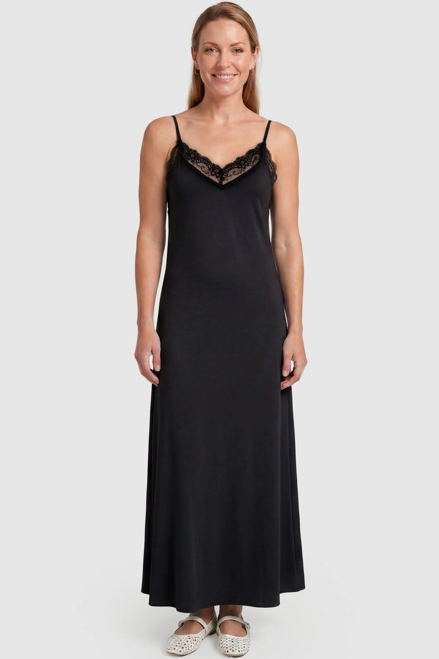 Lace-Trim Maternity Slip Dress Lace-Trim Maternity Slip Dress in Black featuring delicate spaghetti straps on a non-pregnant model, front view.