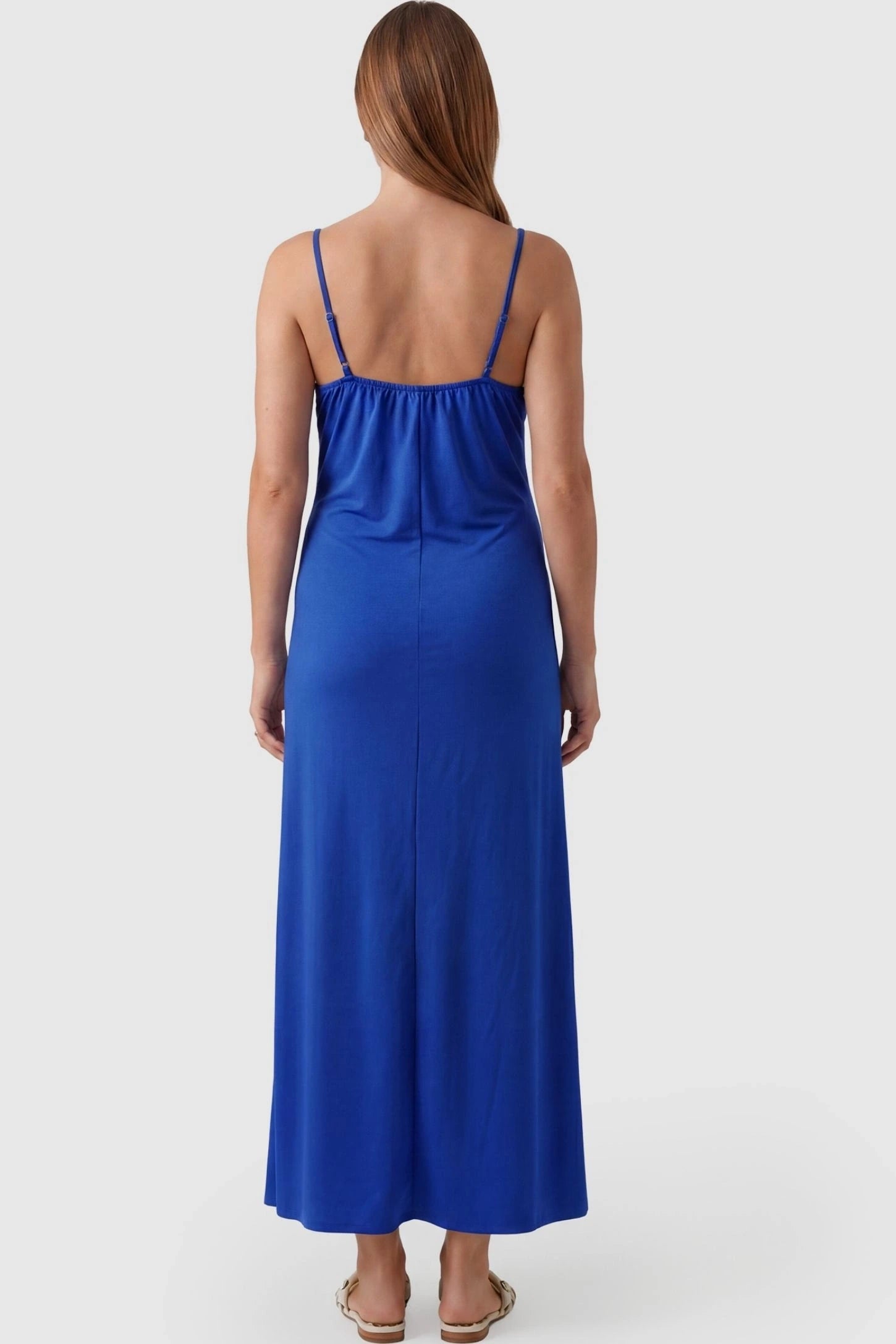Lace-Trim Maternity Slip Dress Lace-Trim Maternity Slip Dress in Blue featuring thin spaghetti straps on a pregnant model, back view.
