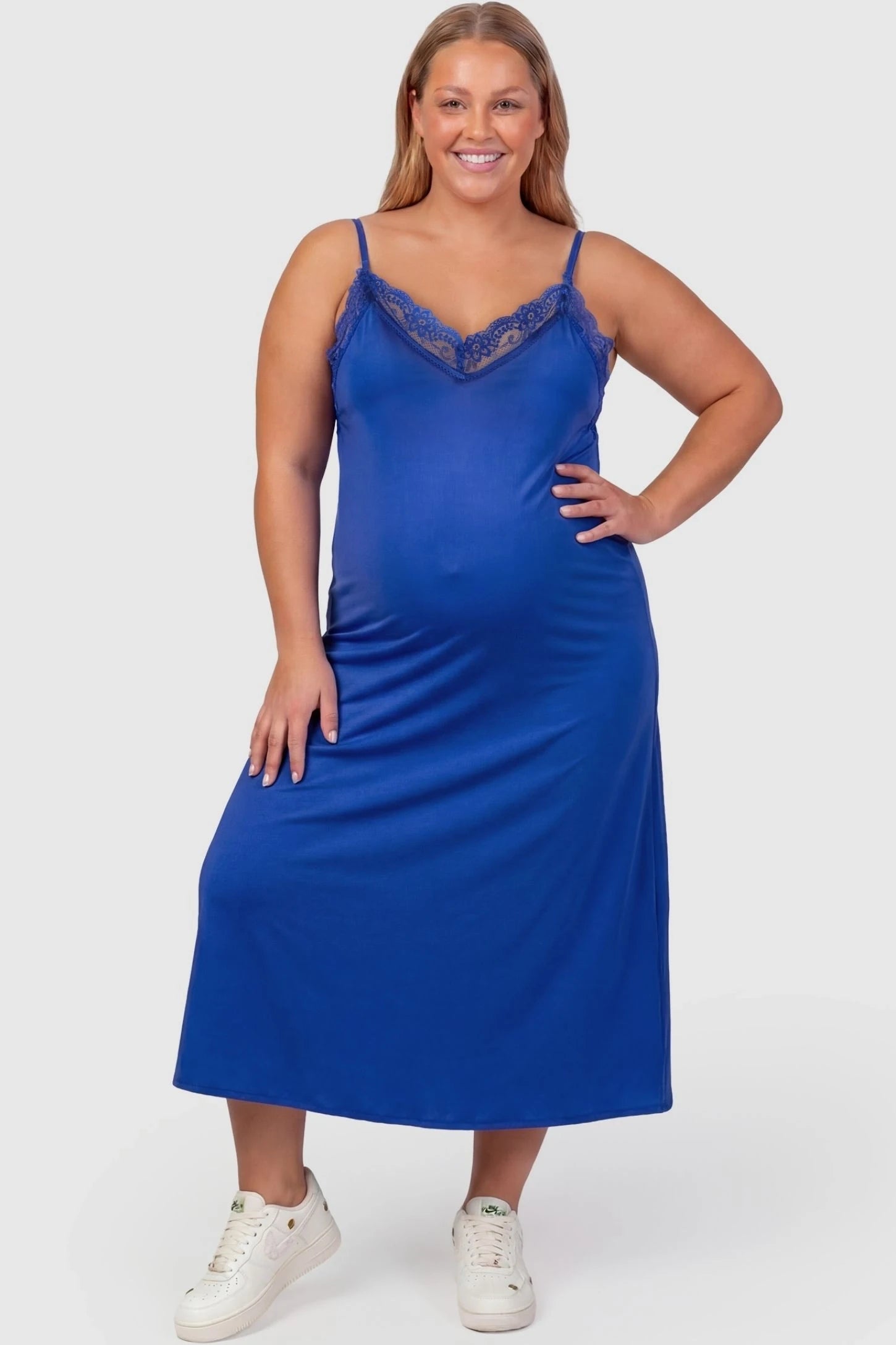 Lace-Trim Maternity Slip Dress Lace-Trim Maternity Slip Dress in Blue featuring delicate spaghetti straps on a plus-size pregnant model, front view.