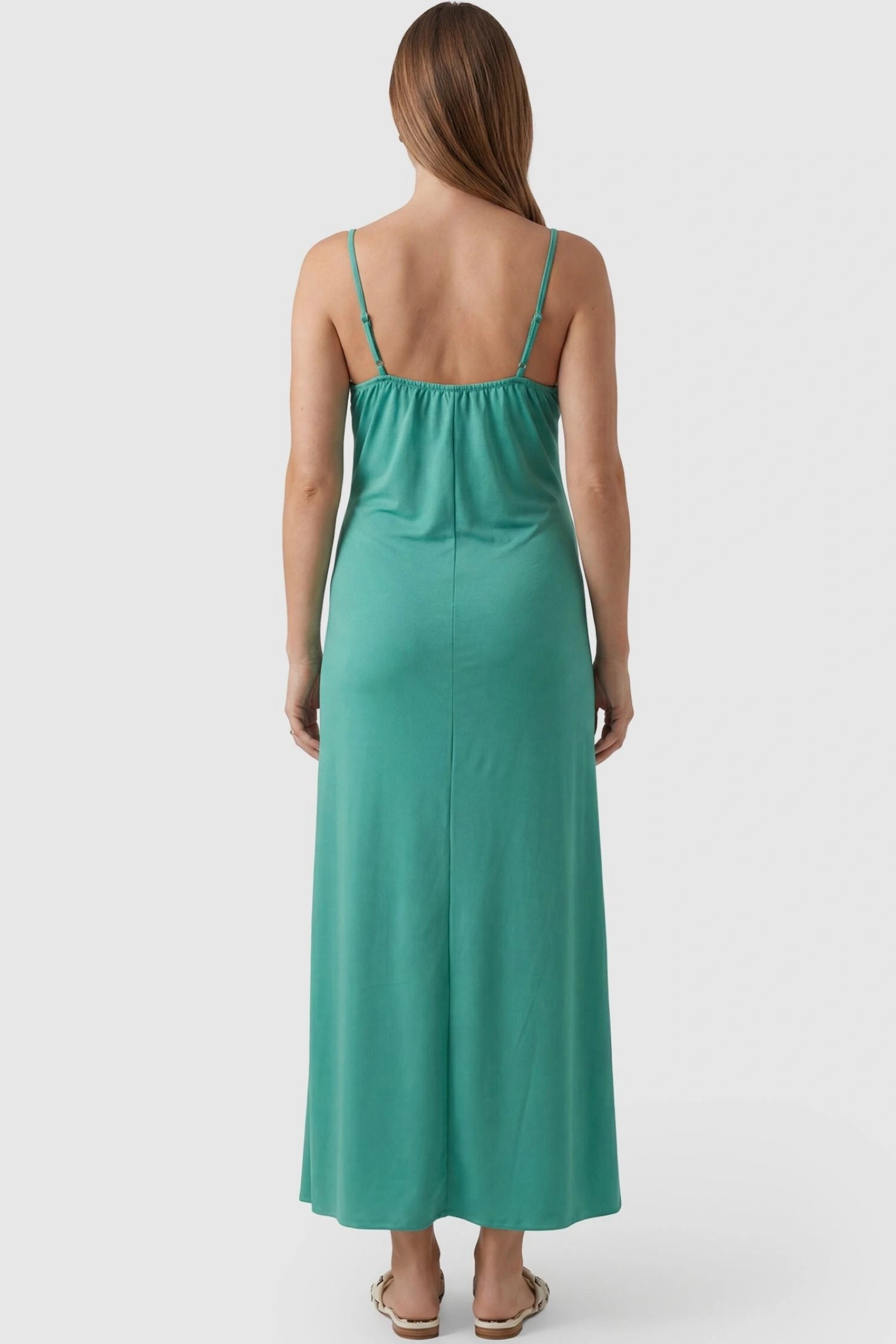Lace-Trim Maternity Slip Dress Lace-Trim Maternity Slip Dress in Green featuring thin spaghetti straps on a pregnant model, back view.