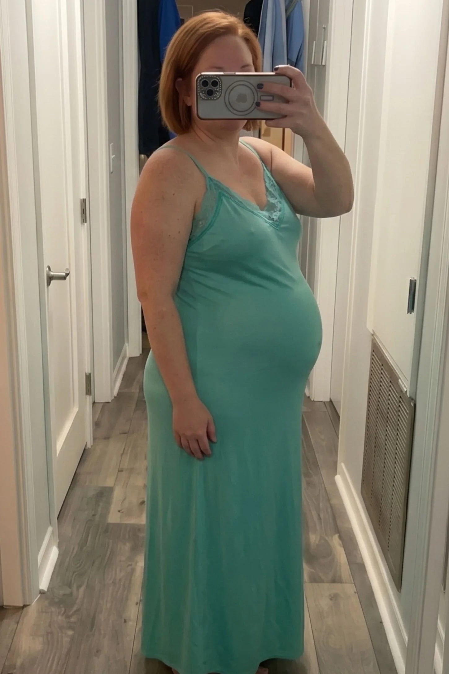 Lace-Trim Maternity Slip Dress Lace-Trim Maternity Slip Dress in Green featuring sleek spaghetti straps on a pregnant model, mirror selfie view.