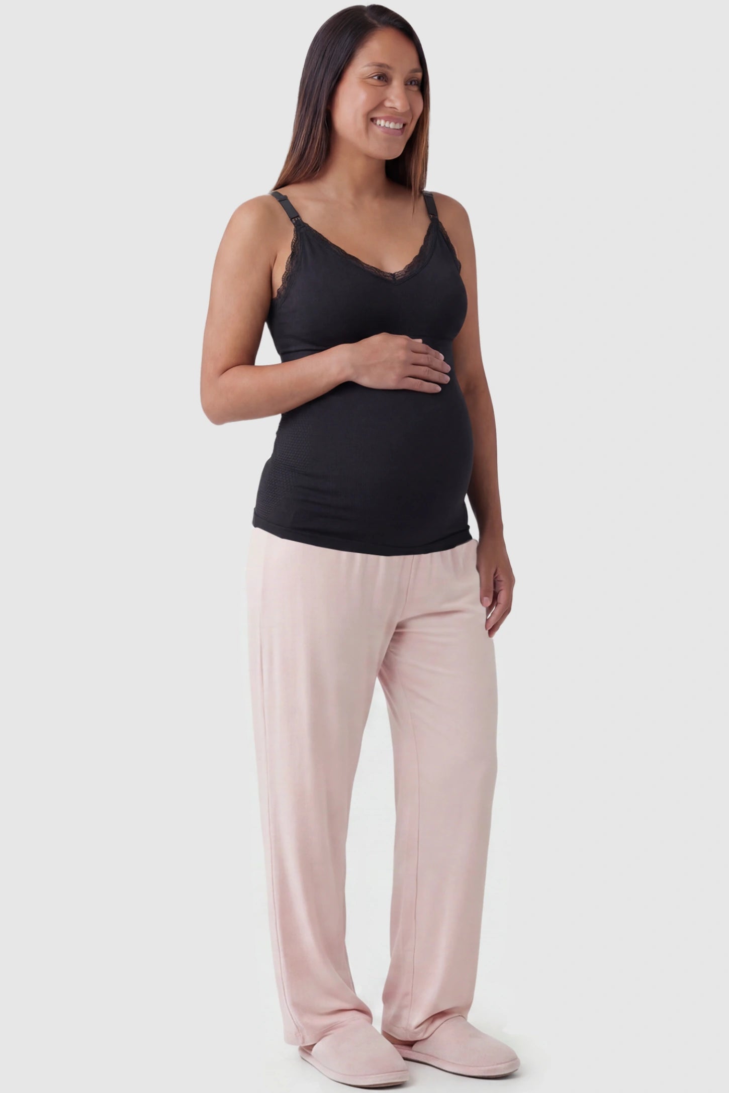 Lace Trim Wire Free Maternity Nursing Camisole Lace Trim Wire Free Maternity Nursing Camisole in black offering one-handed nursing access on a pregnant model, full body view.