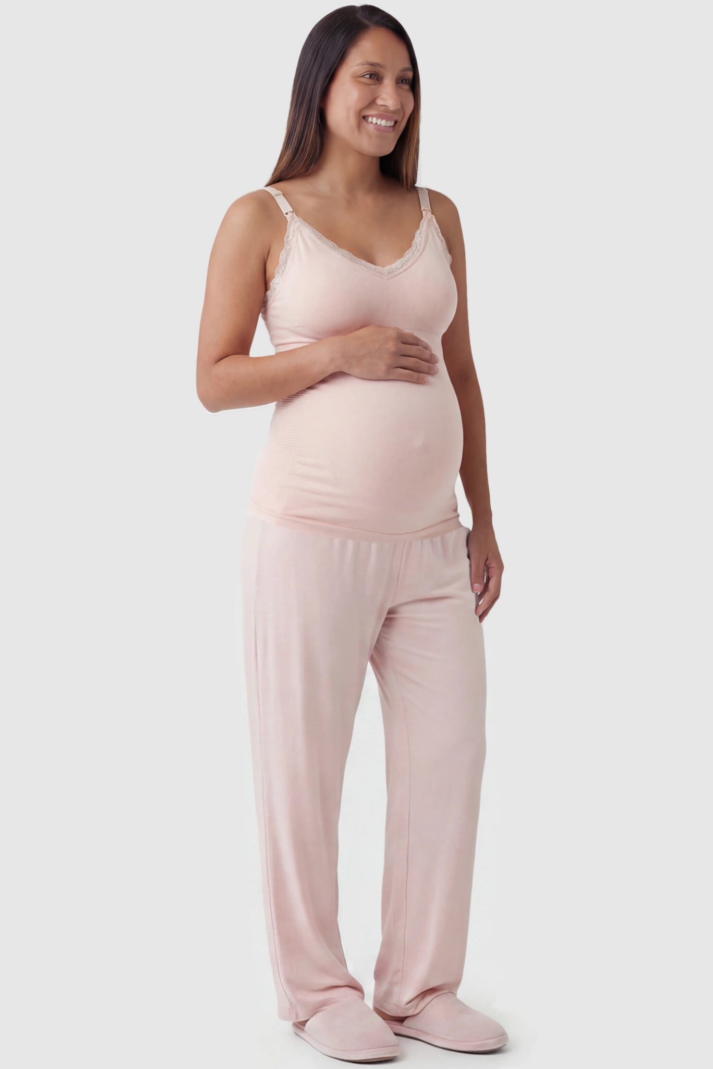 Lace Trim Wire Free Maternity Nursing Camisole Lace Trim Wire Free Maternity Nursing Camisole in light pink offering one-handed nursing access on a pregnant model, full body view.