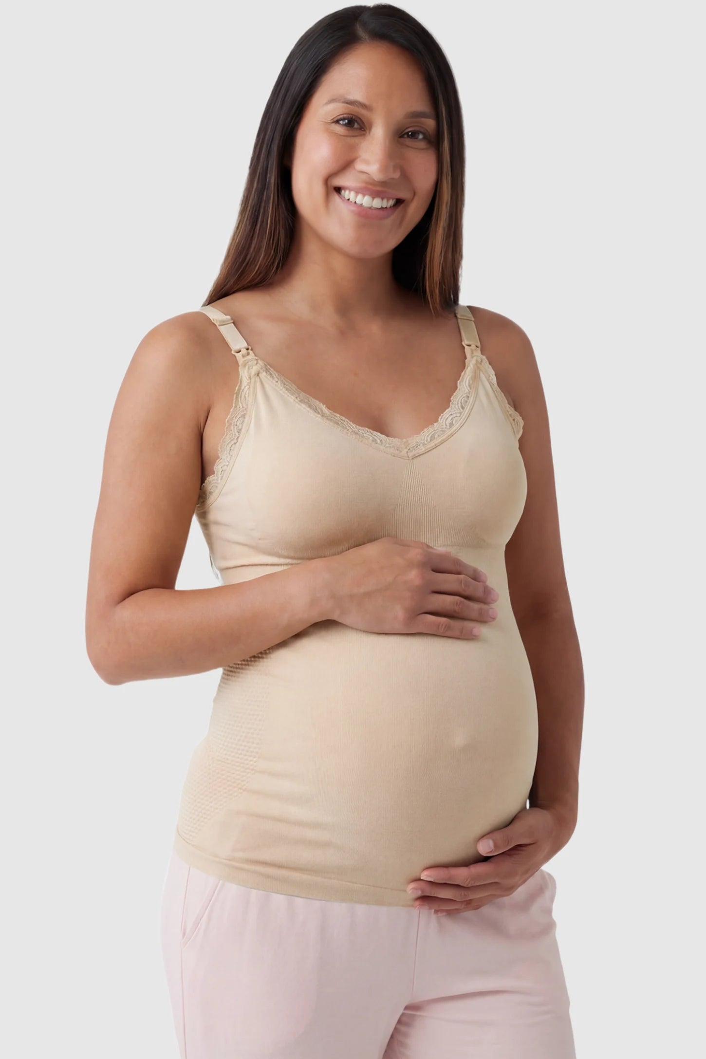 Lace Trim Wire Free Maternity Nursing Camisole Lace Trim Wire Free Maternity Nursing Camisole in skin tone offering one-handed nursing access on a pregnant model, front view.