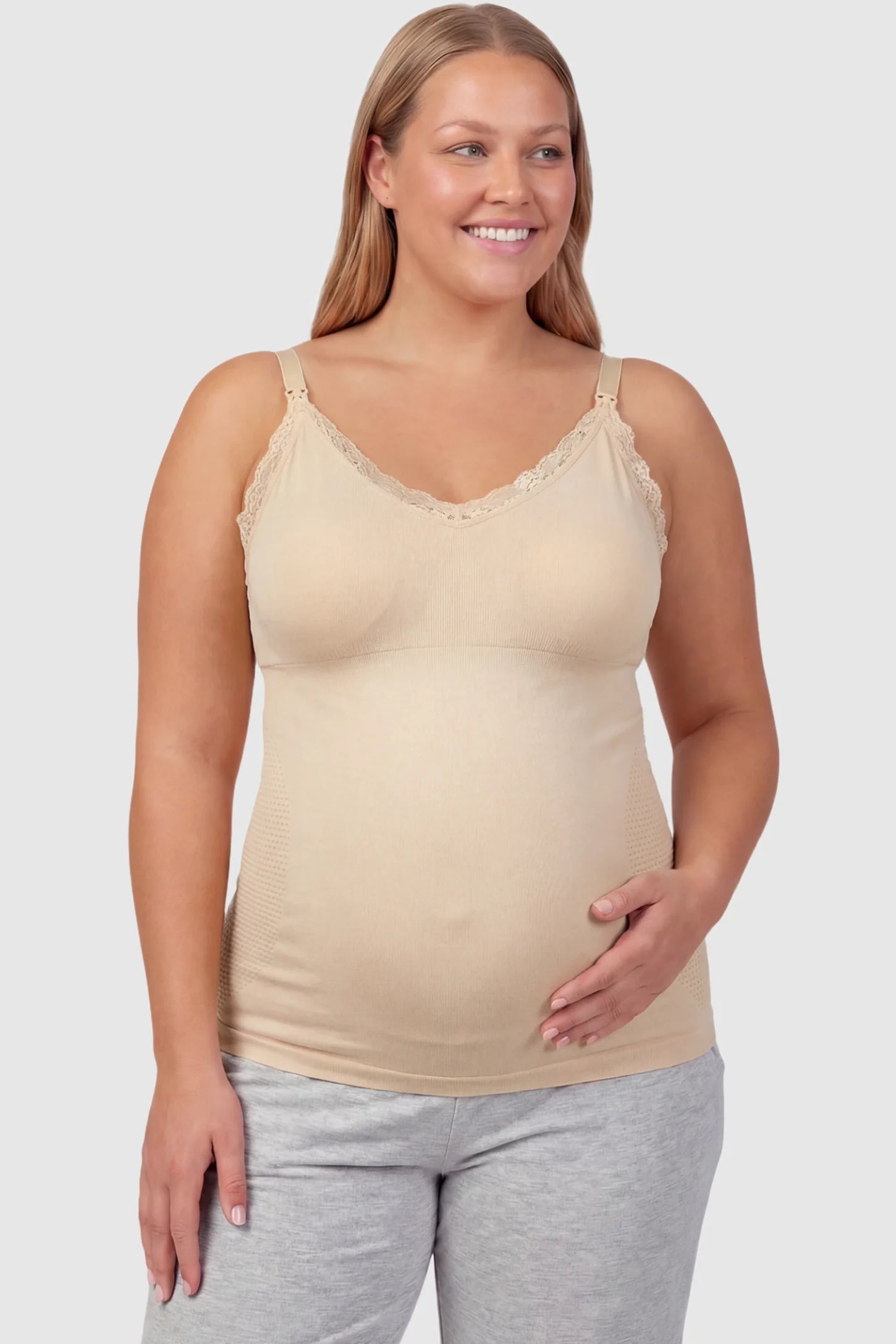 Lace Trim Wire Free Maternity Nursing Camisole Lace Trim Wire Free Maternity Nursing Camisole in skin tone offering one-handed nursing access on a plus size pregnant model, front view.