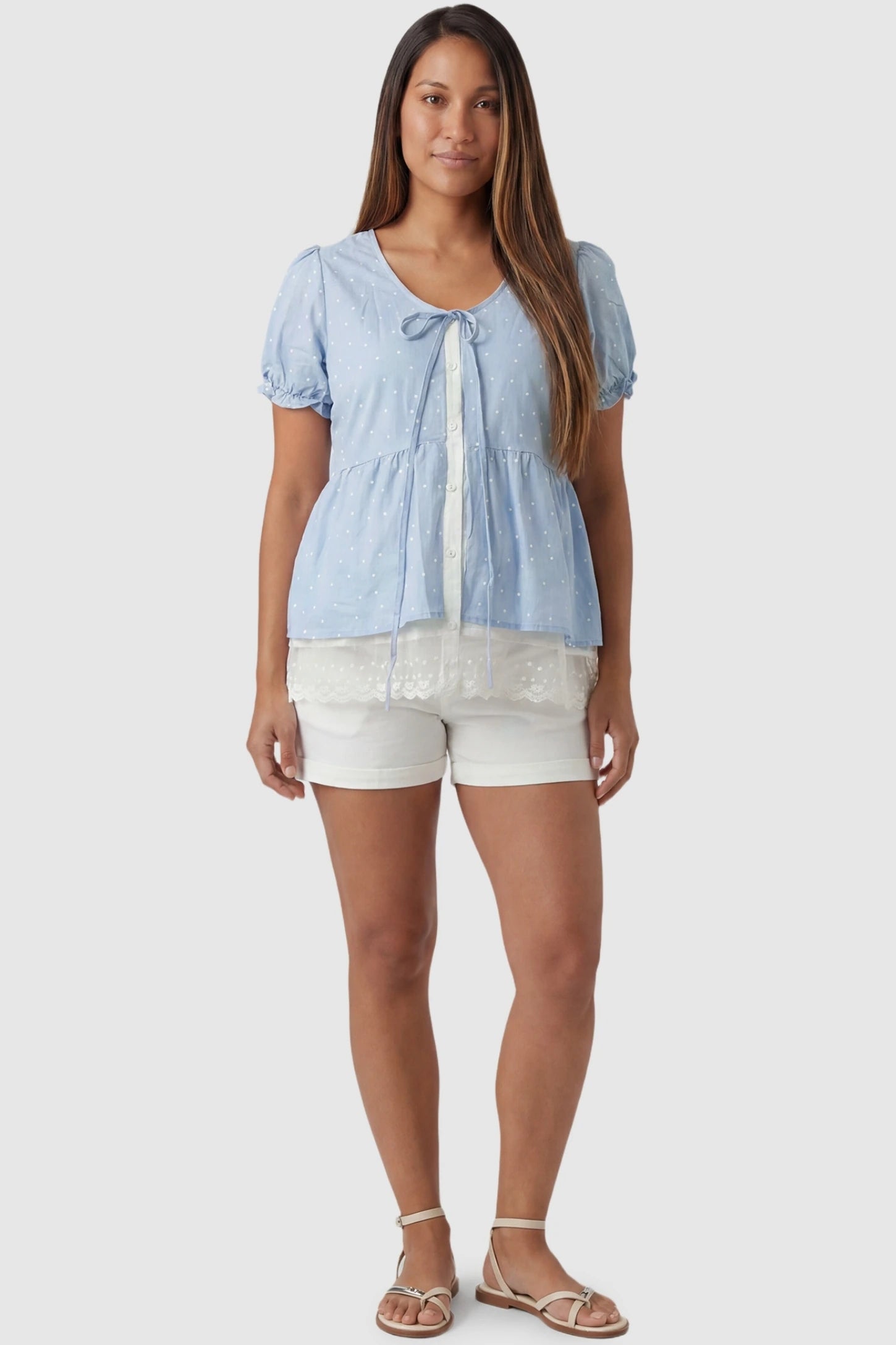 Laced Polka Dot Babydoll Maternity Blouse Laced Polka Dot Babydoll Maternity Blouse in Blue featuring a lace-trimmed hem on a non-pregnant model, full body front view.