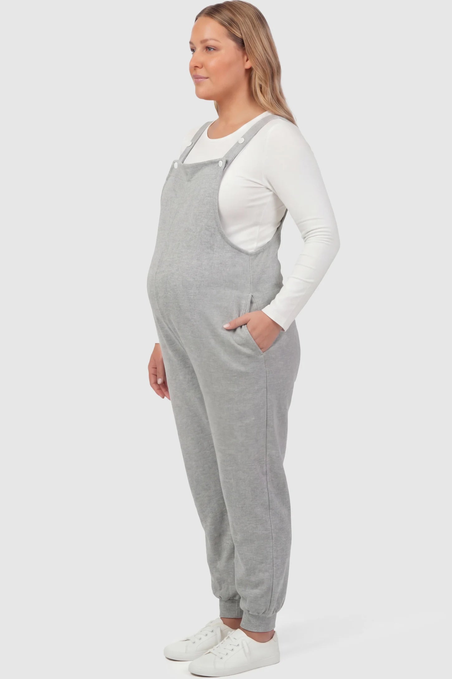 Sleeveless Square Neck Maternity Jogger Jumpsuit in Gray Jersey Knit with deep side pockets on a pregnant model.