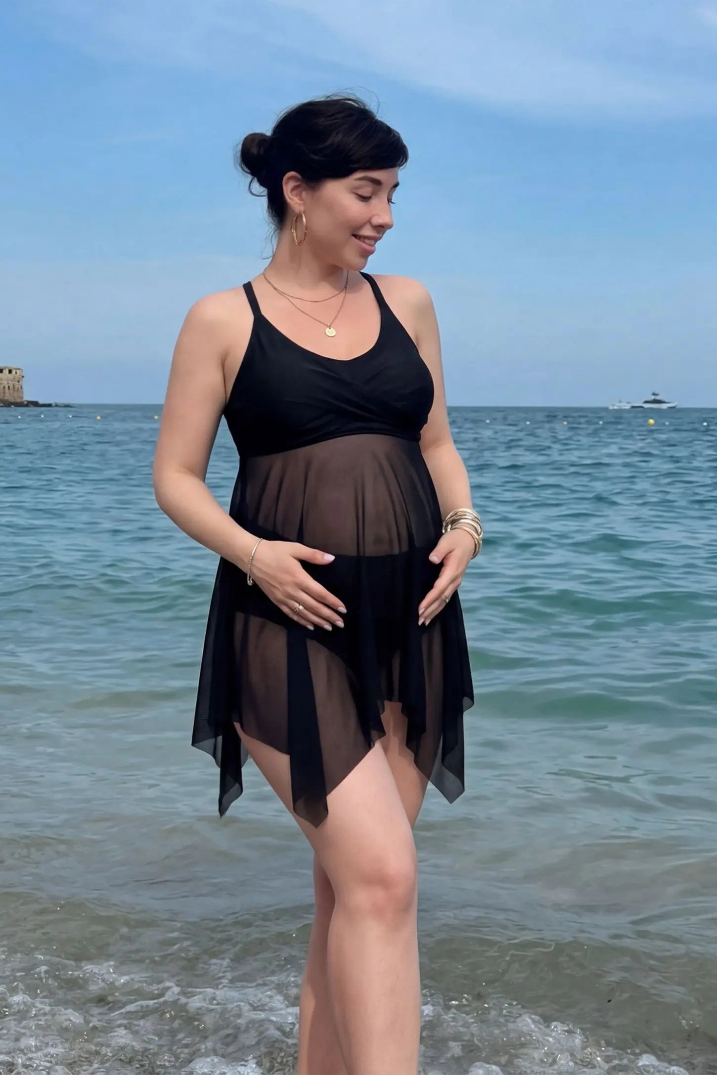 esh Overlay Crisscross Back Maternity Bikini Set in Black featuring a bump-flattering mesh overlay on a pregnant model, lifestyle view.